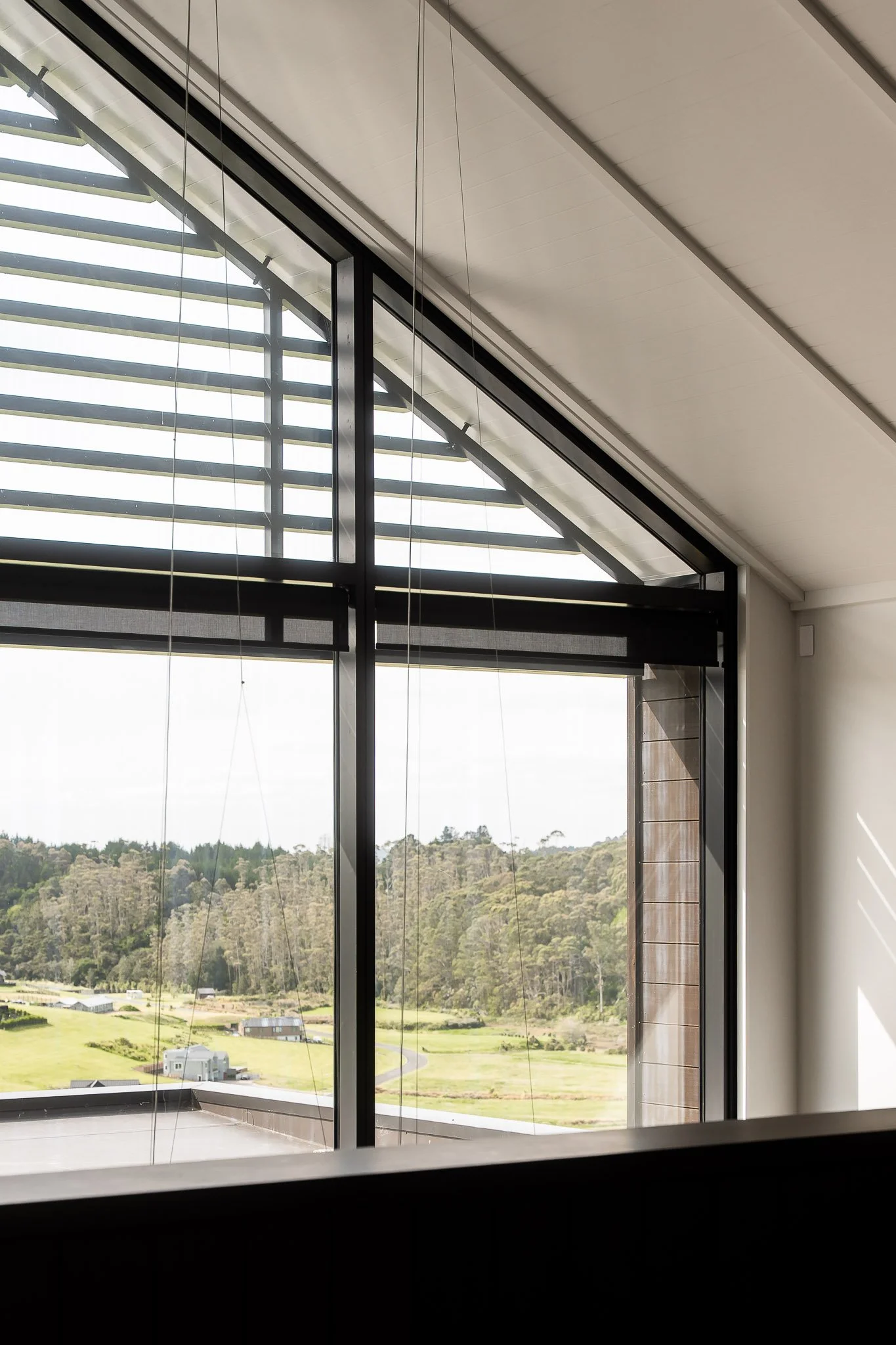 Architectural feature trusses exposed in gabled ceiling, celebrating structure and light.