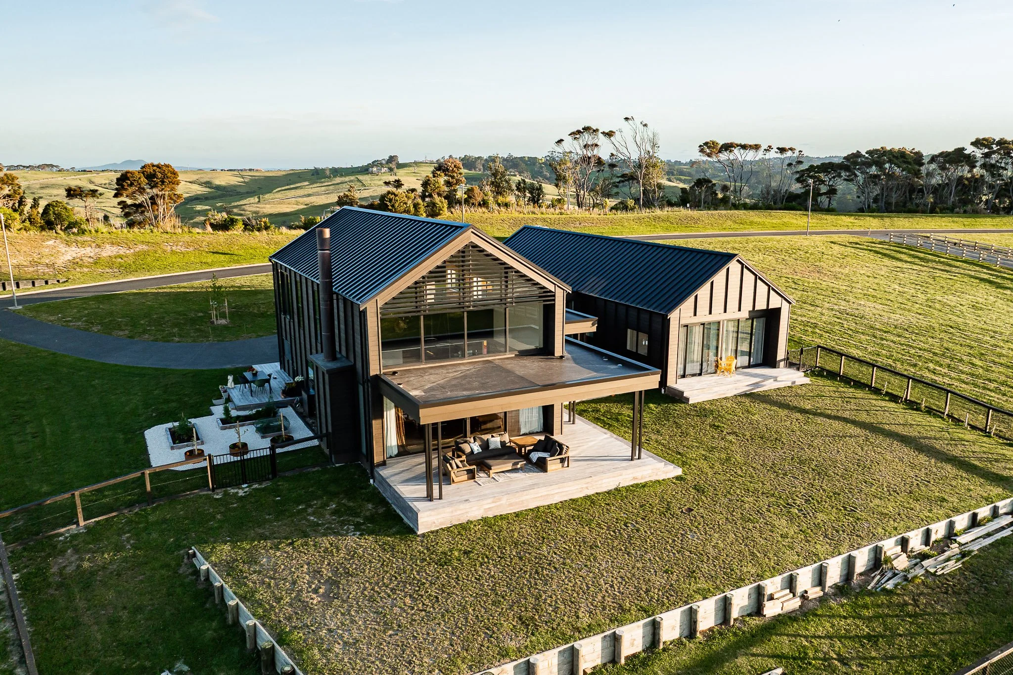 Timber pergola and deep deck overlooking rural Weiti Bay setting, ideal for indoor-outdoor entertaining.