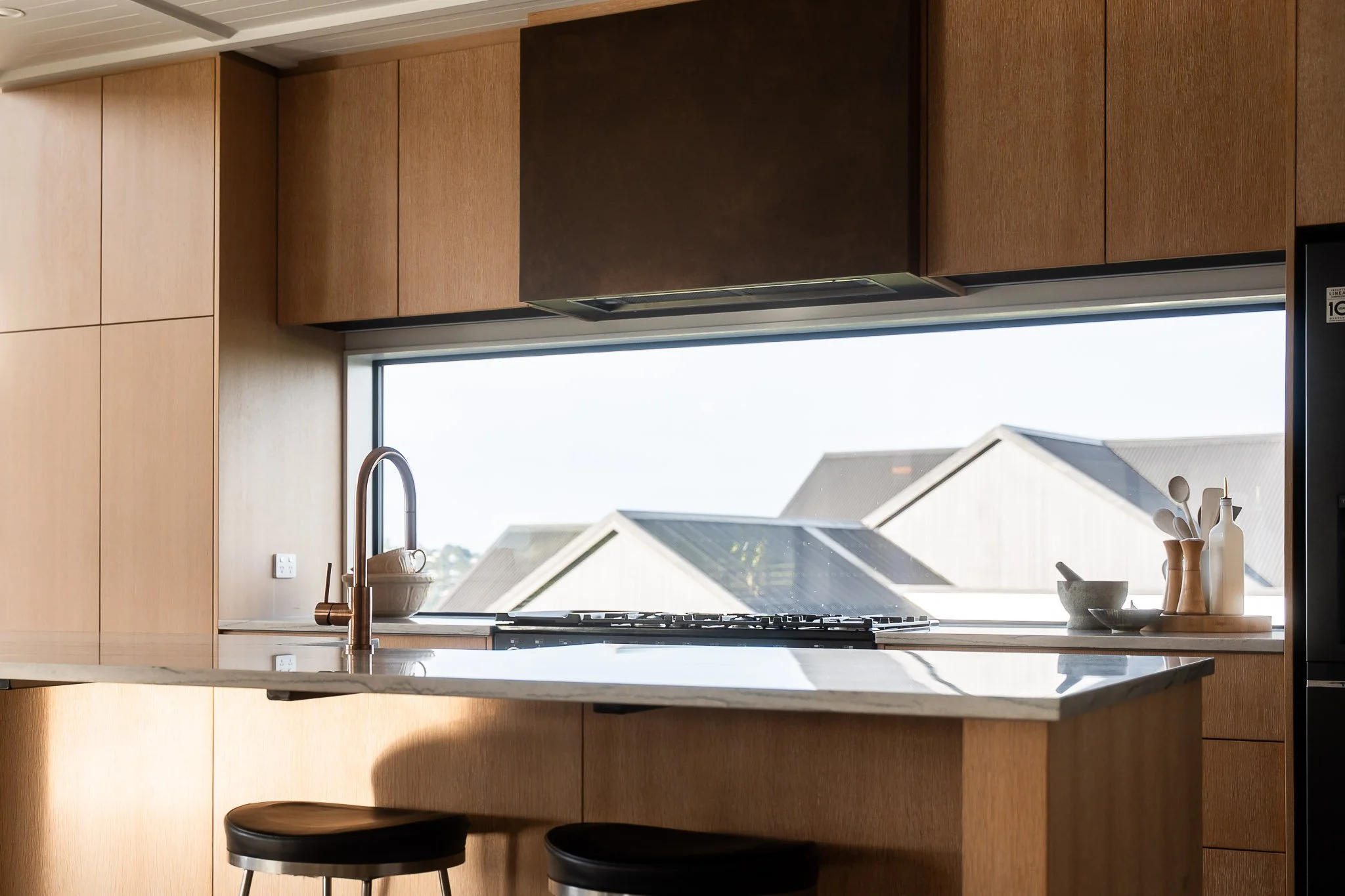 Architectural ceiling details carry from indoors to covered deck for seamless transition.