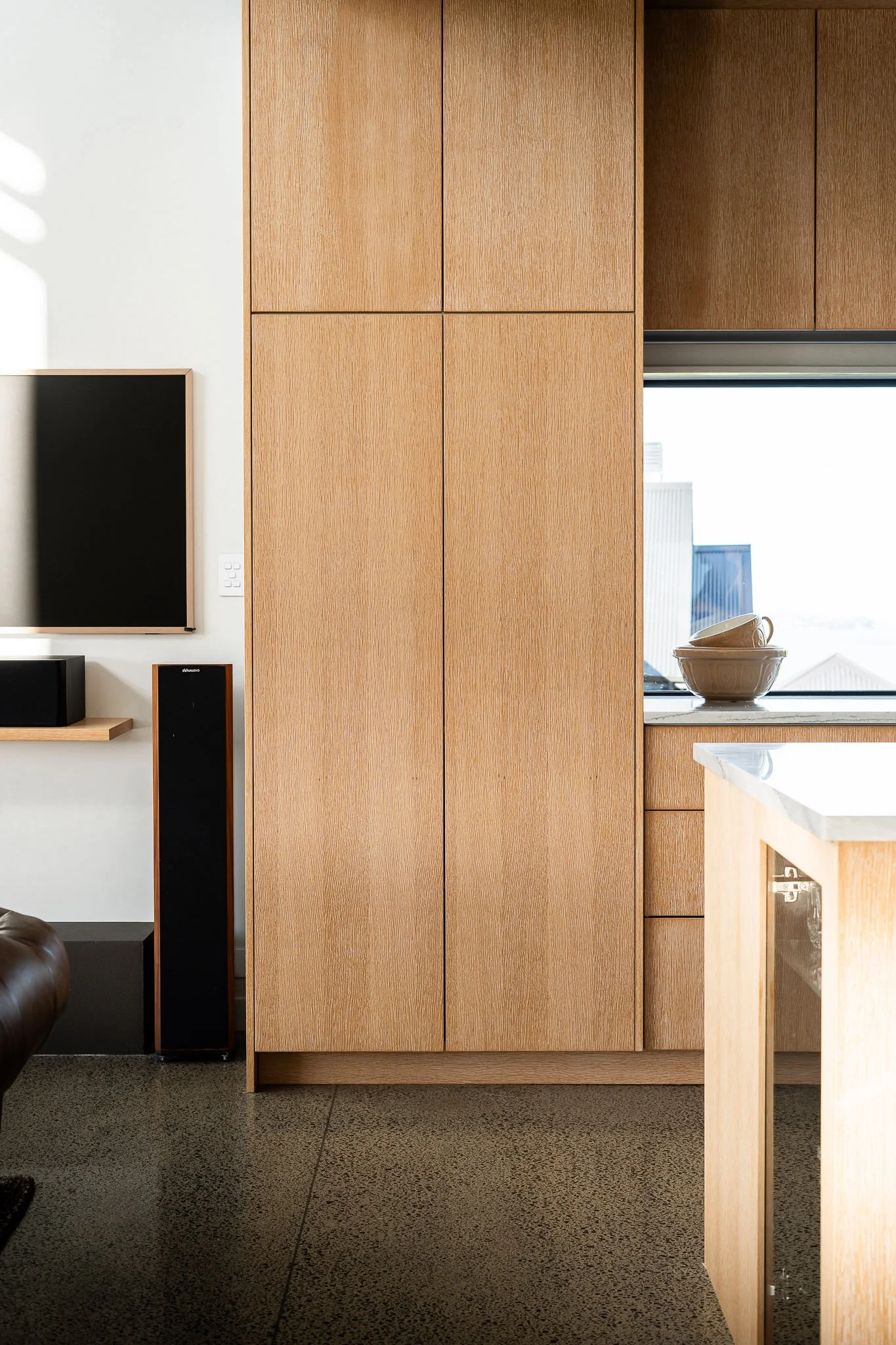 Exterior corner view showcasing blend of vertical cladding and soft exterior tones.