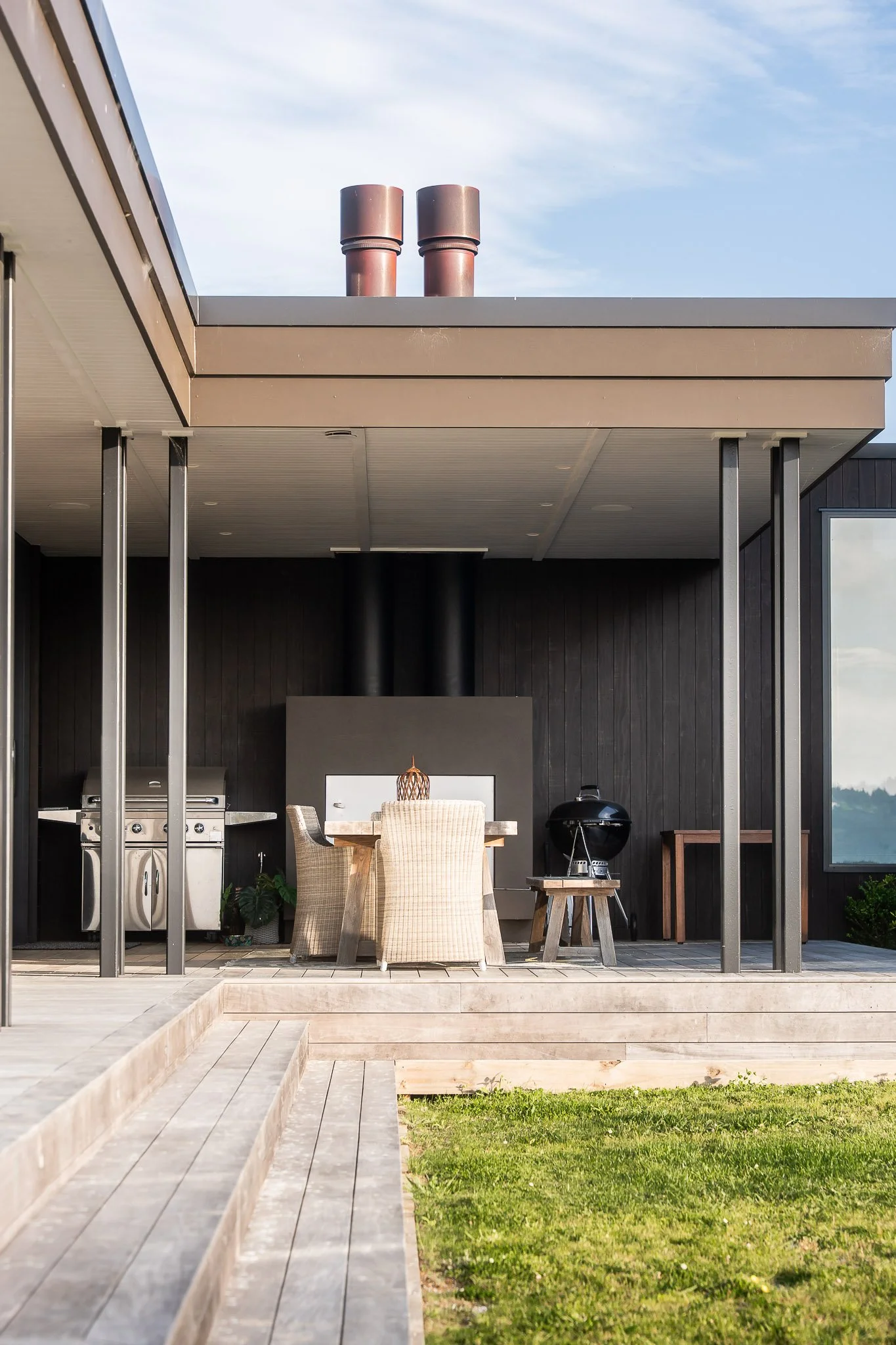 Open-plan layout in this premium home construction Auckland, anchored by modern country home and natural textures.