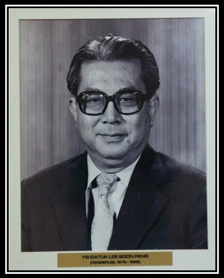 A black and white formal portrait of a man wearing glasses, a suit, and a tie, with a wooden panel background. A caption below includes his name, Y.B. Datuk Lee Boon Peng, and notes he was a president from 1978 to 1980.
