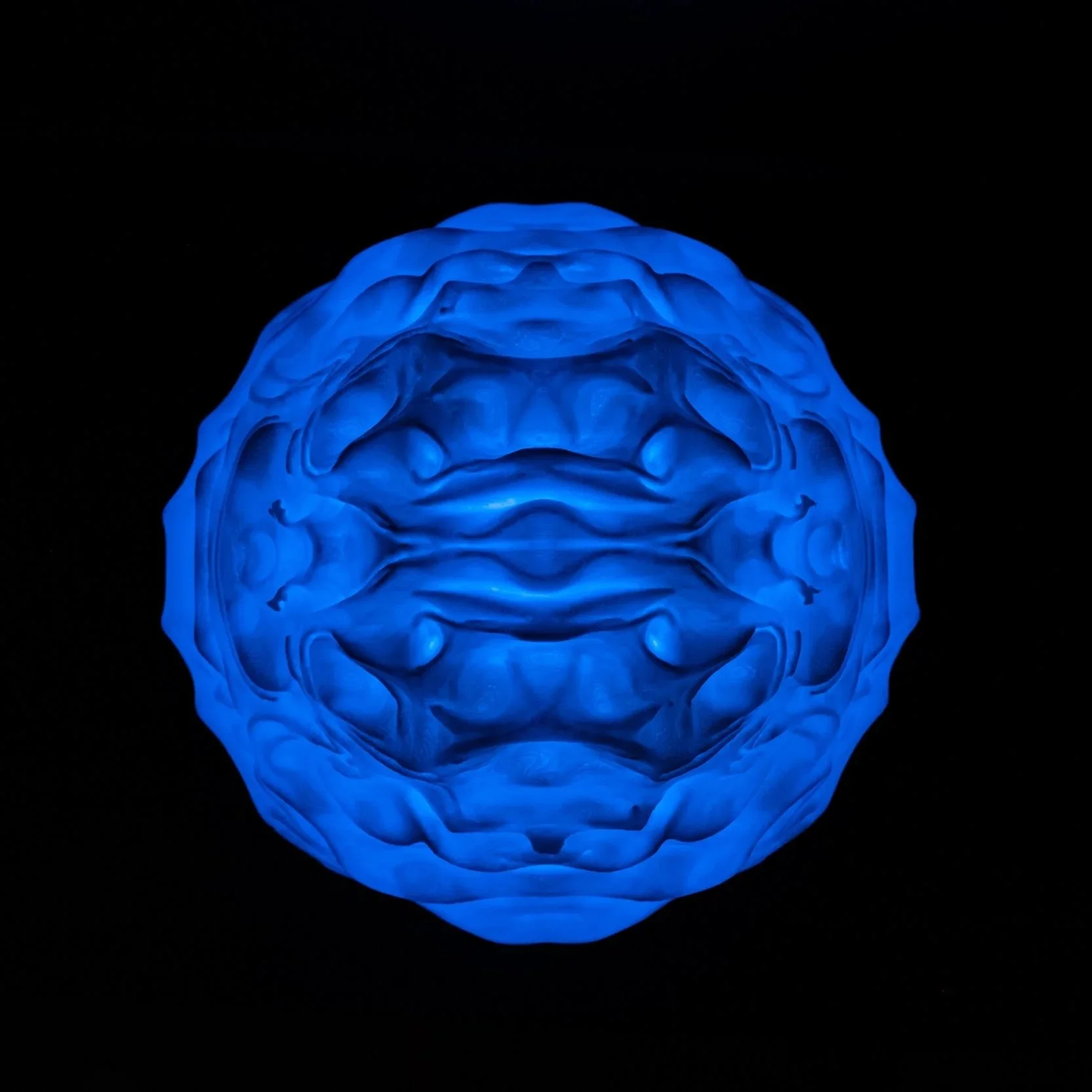 Syzygy resting within an interior setting, creating a calm, ambient presence.