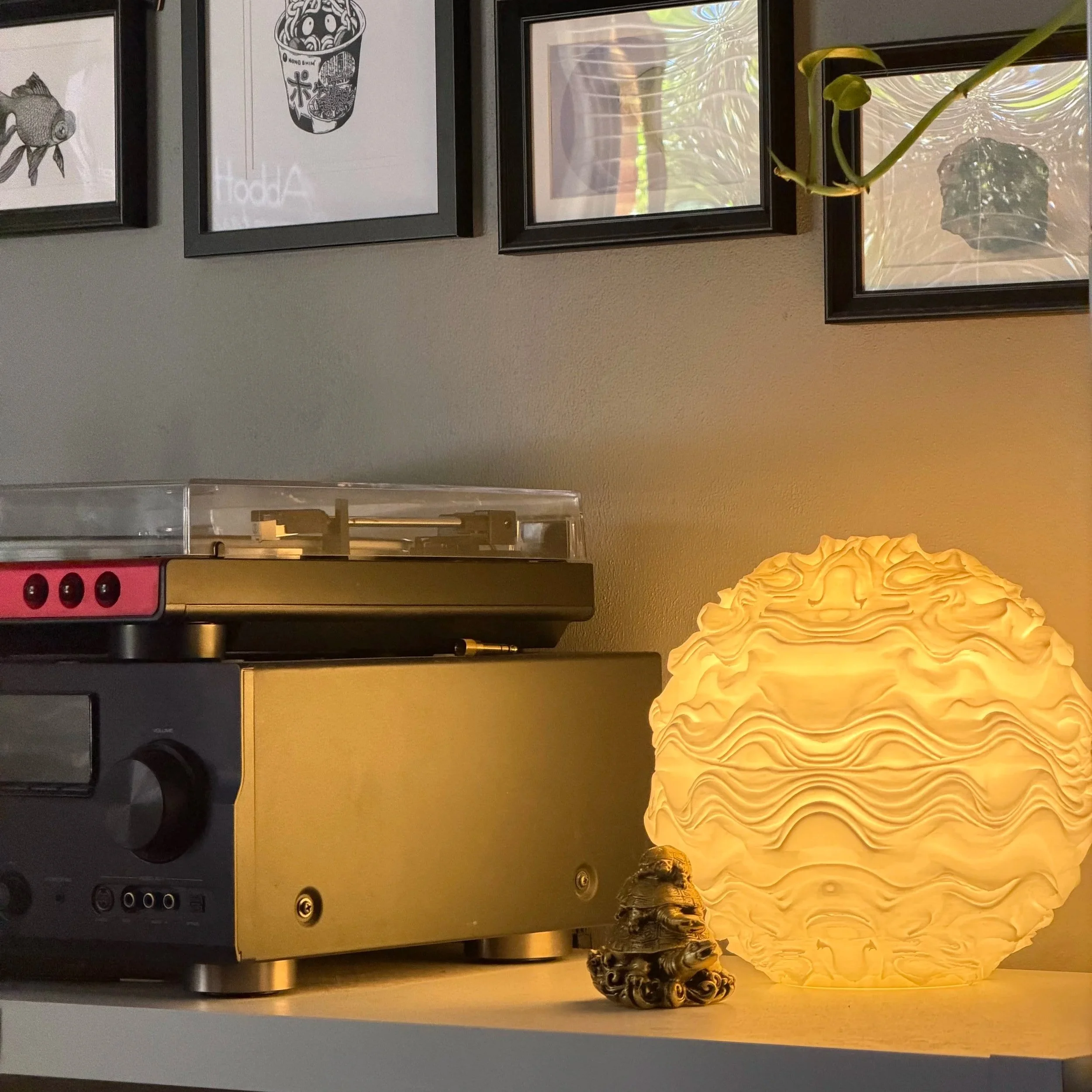 Syzygy resting within an interior setting, creating a calm, ambient presence.