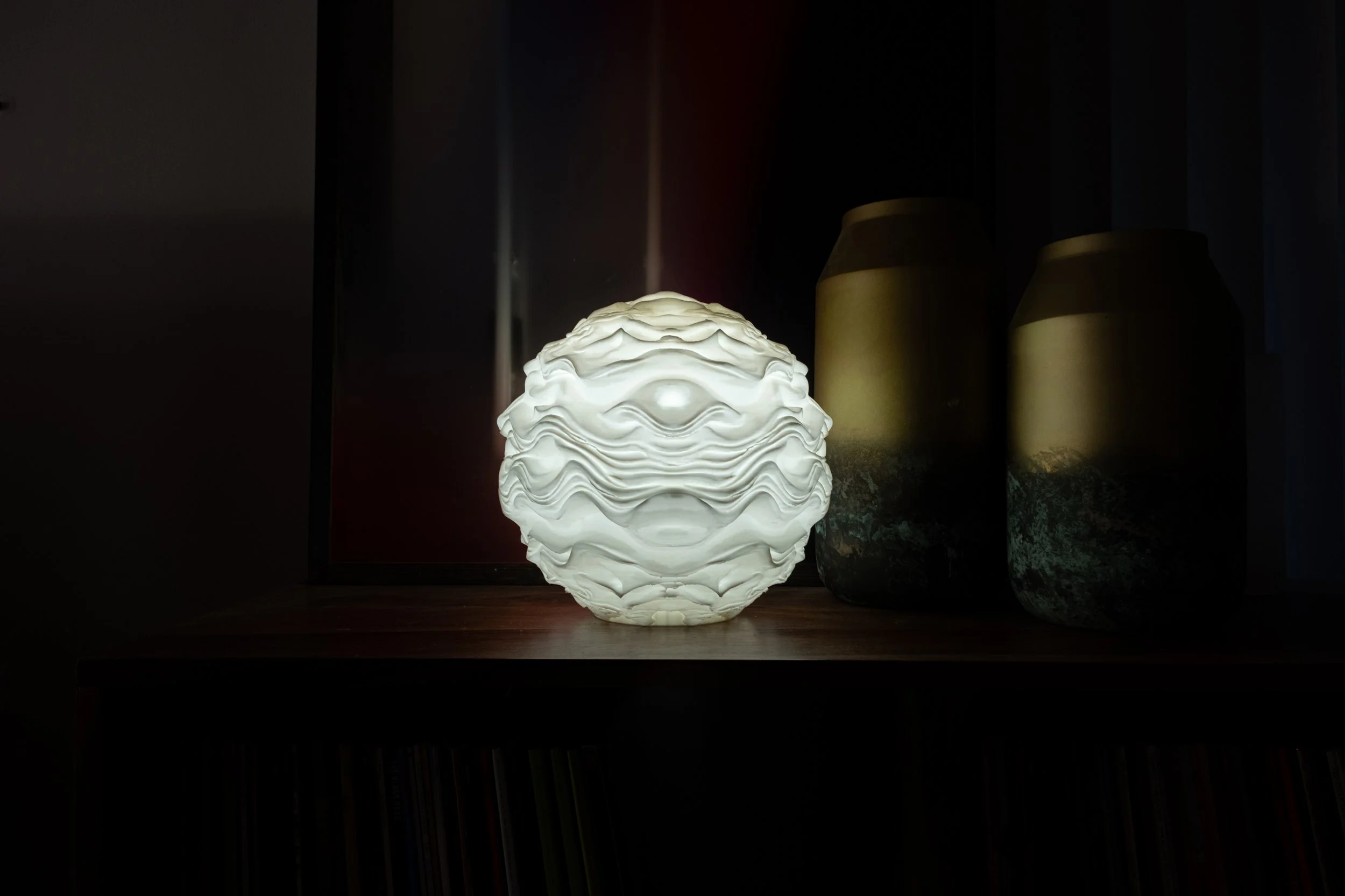 Syzygy resting within an interior setting, creating a calm, ambient presence.