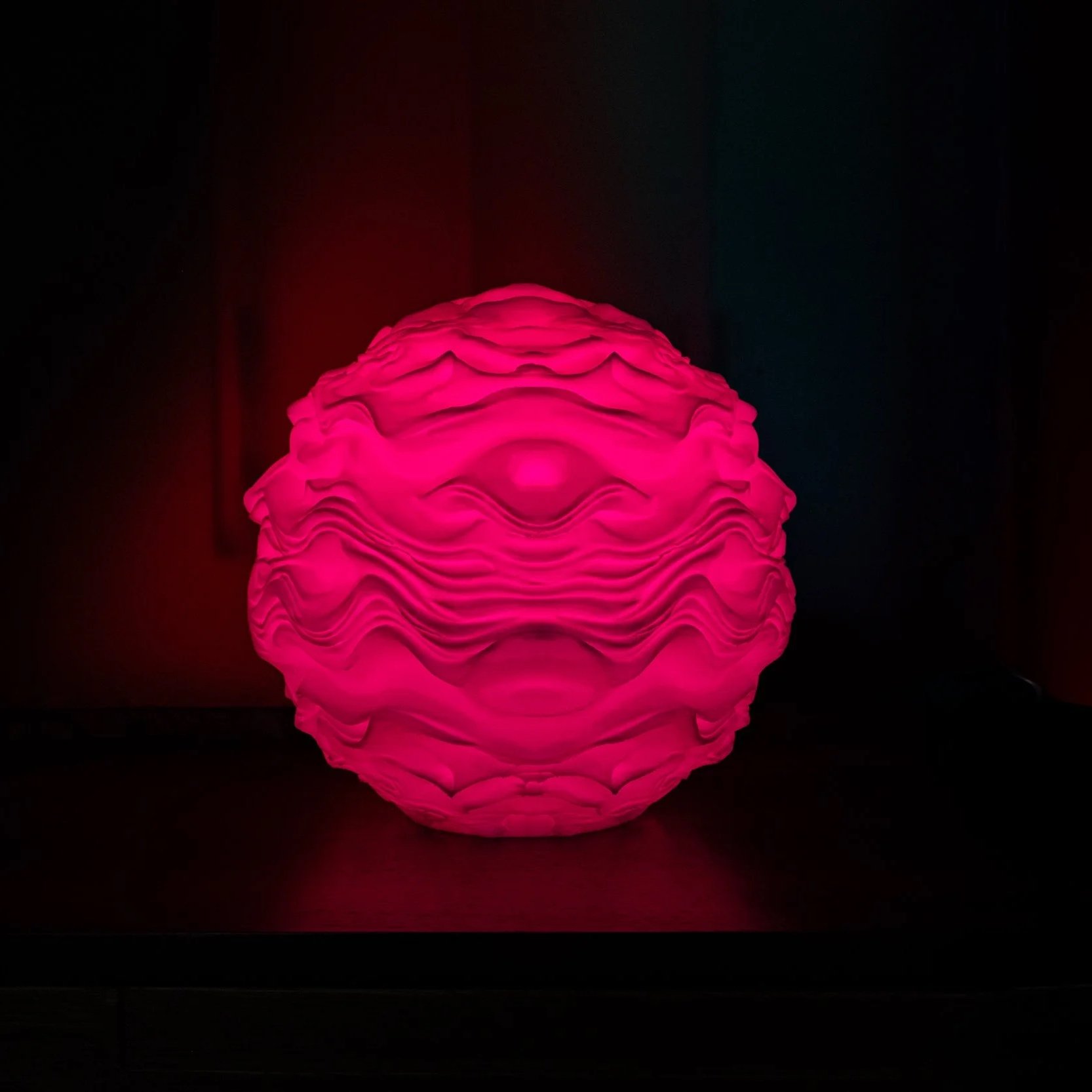 Syzygy resting within an interior setting, creating a calm, ambient presence.