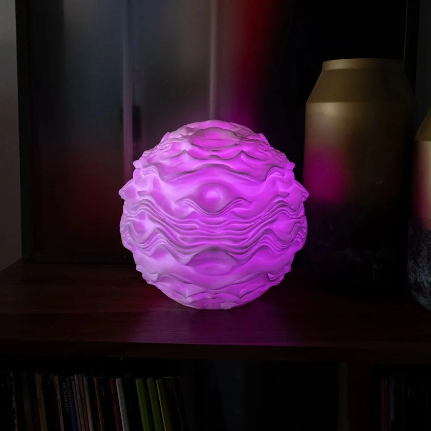 Syzygy resting within an interior setting, creating a calm, ambient presence.