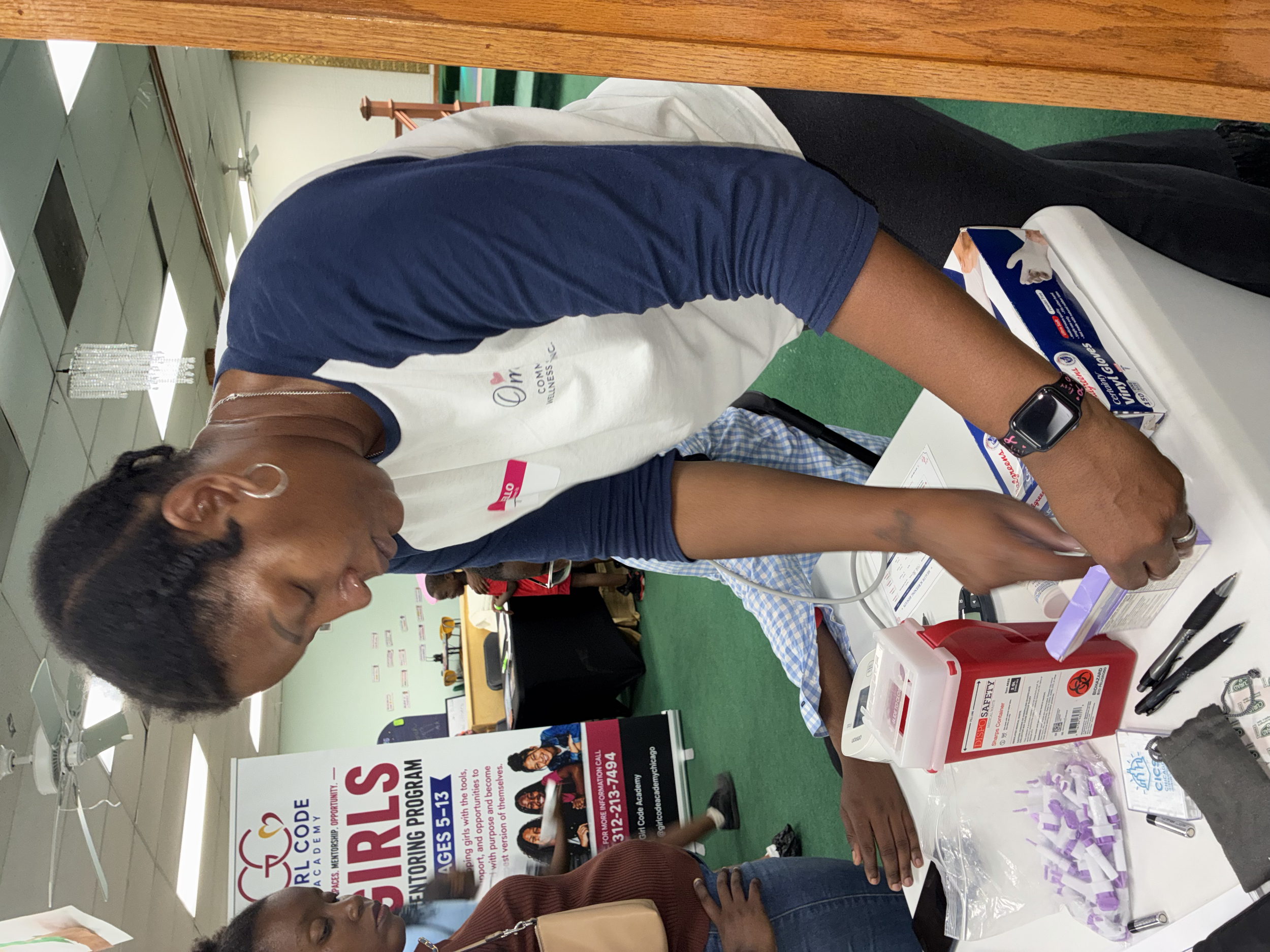 People participating in a community event or health fair, with a focus on health awareness and information distribution.
