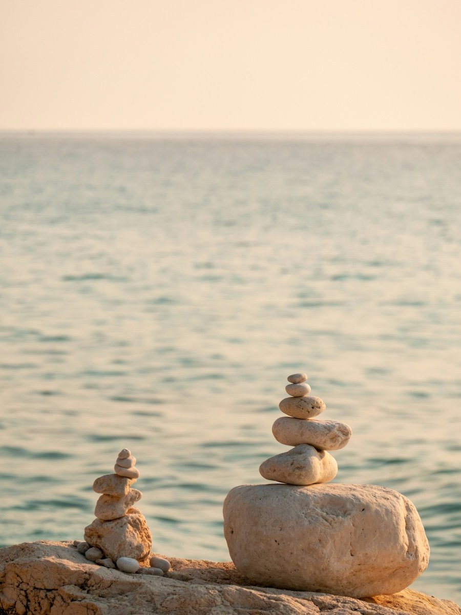 Balanced stones representing nervous system regulation and holistic fertility support in Adelaide, Australia.