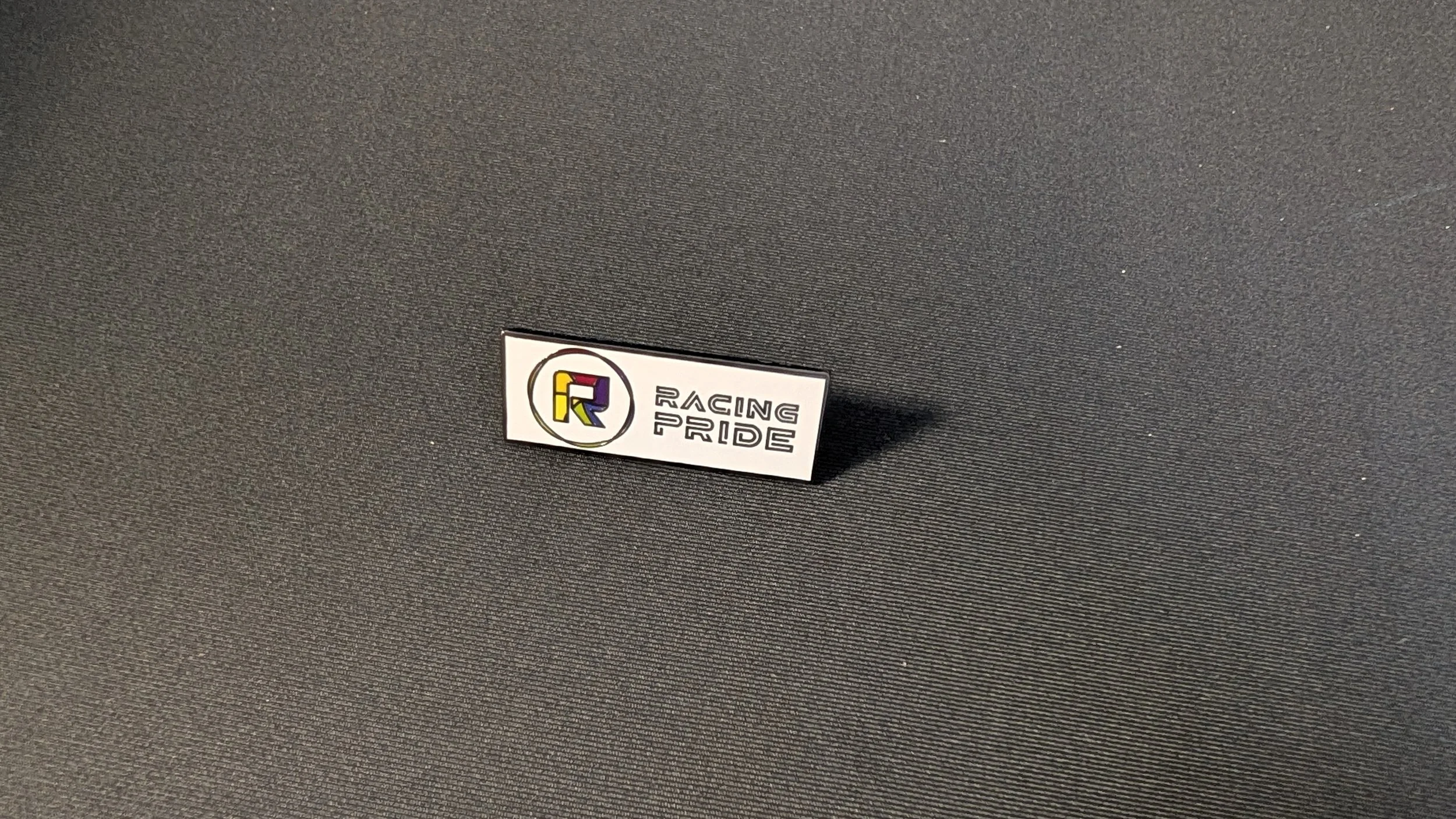 Racing Pride Hard Enamel Pin — Raised Metal Black Nickel