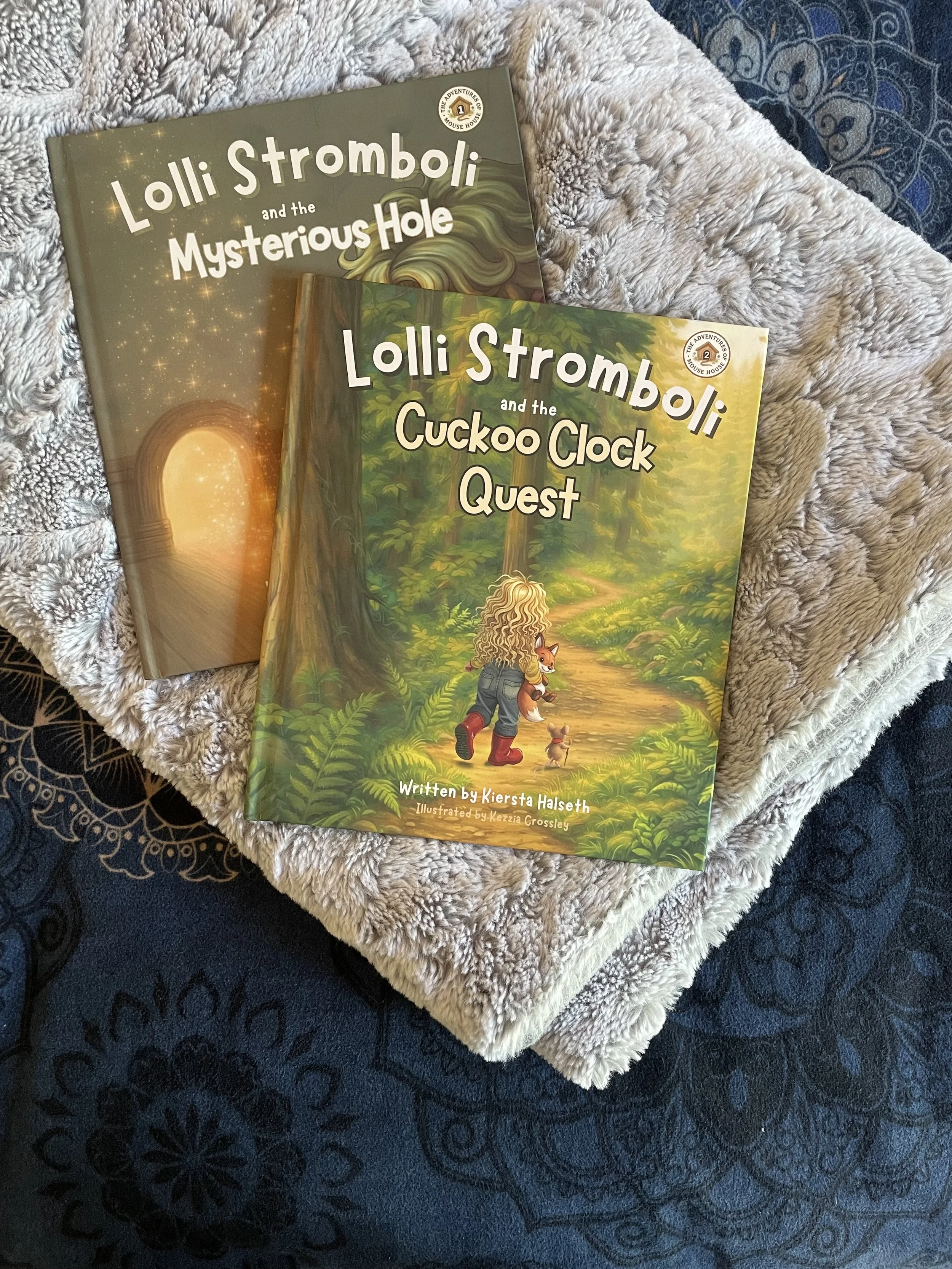 Lolli Stromboli children’s bedtime books lying on a bed, representing book availability through Amazon, bookstores, and libraries.