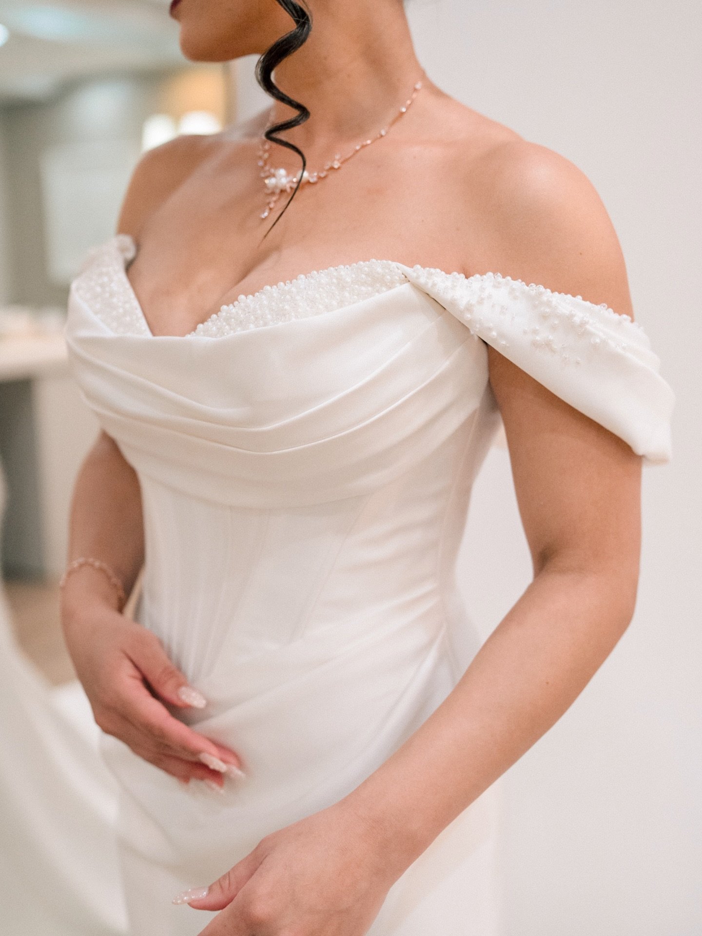 Pearl beading. Draped satin. Off-the-shoulder perfection. Some gowns don&rsquo;t just fit a bride, they become her.

#bridalgown #weddingdress #weddingdressdetail #bridalera