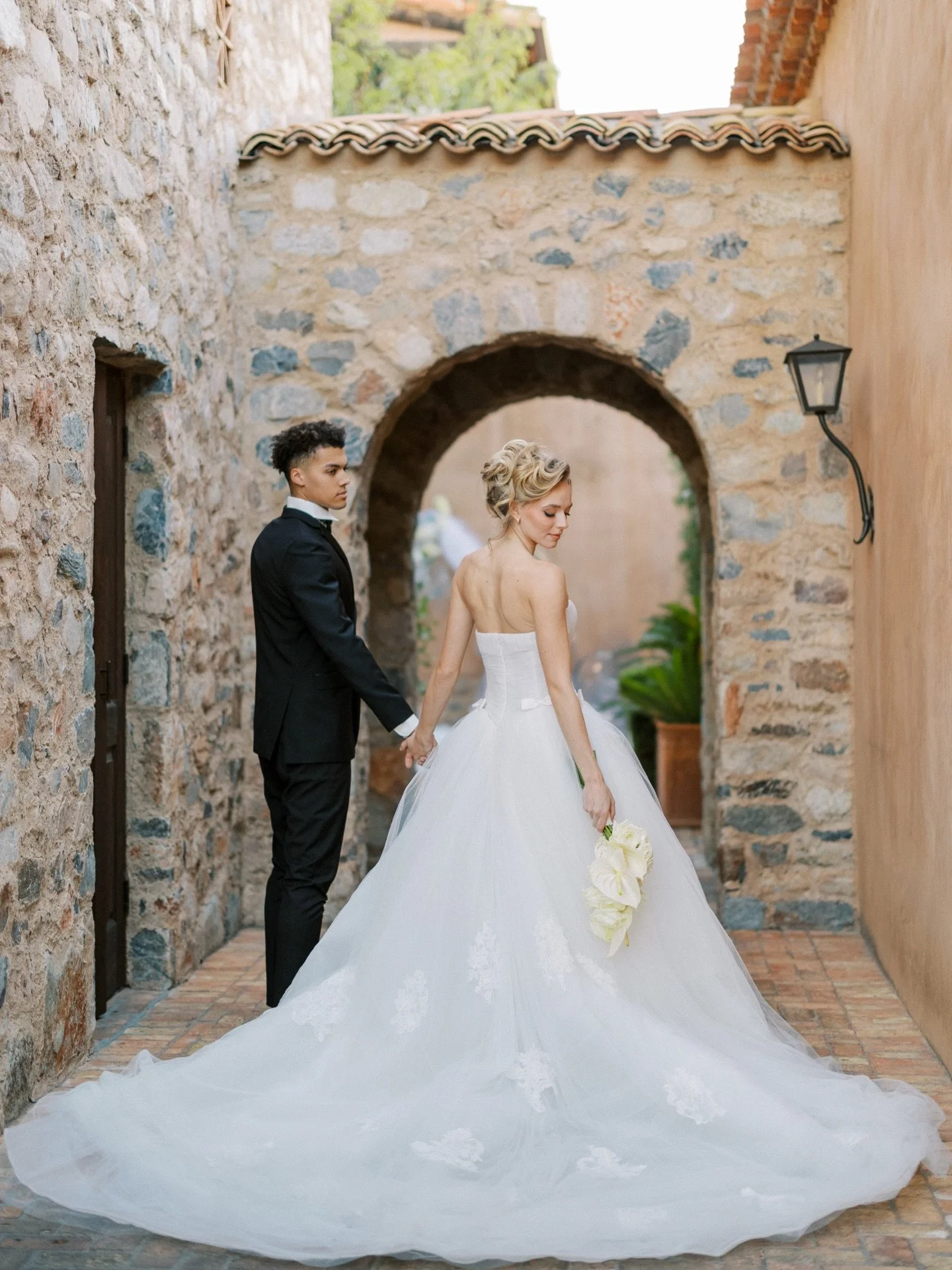 Stone walls that have held a thousand stories. Archways that frame a moment like they were built for it.

This is the kind of place that makes you understand why people fly across the world to say their vows somewhere that feels ancient and alive at 