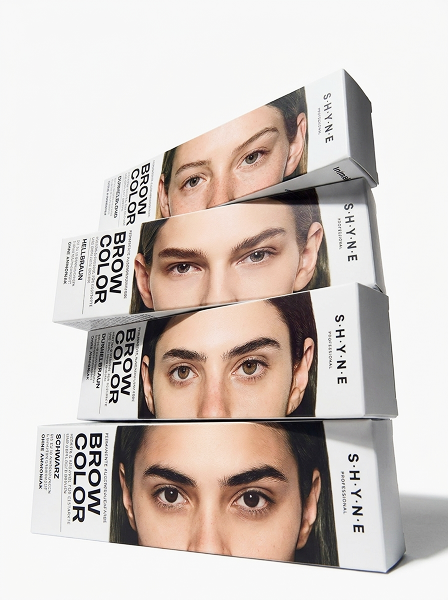 Four stacked boxes of eyebrow coloring product from the brand SHYNE, showing close-up images of a woman's eyebrows on each box.