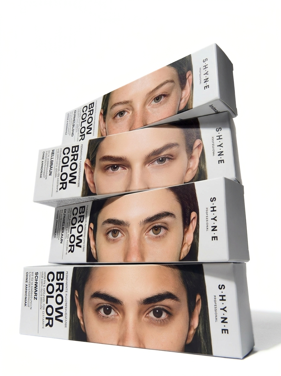 Four boxes of professional eyebrow or brow coloring product stacked, each featuring a woman's eyes and eyebrows on the packaging.
