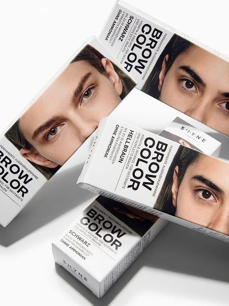 Three boxes of Schwarzkopf brow color hair dye featuring close-up images of male models with different eyebrow colors on a white background.