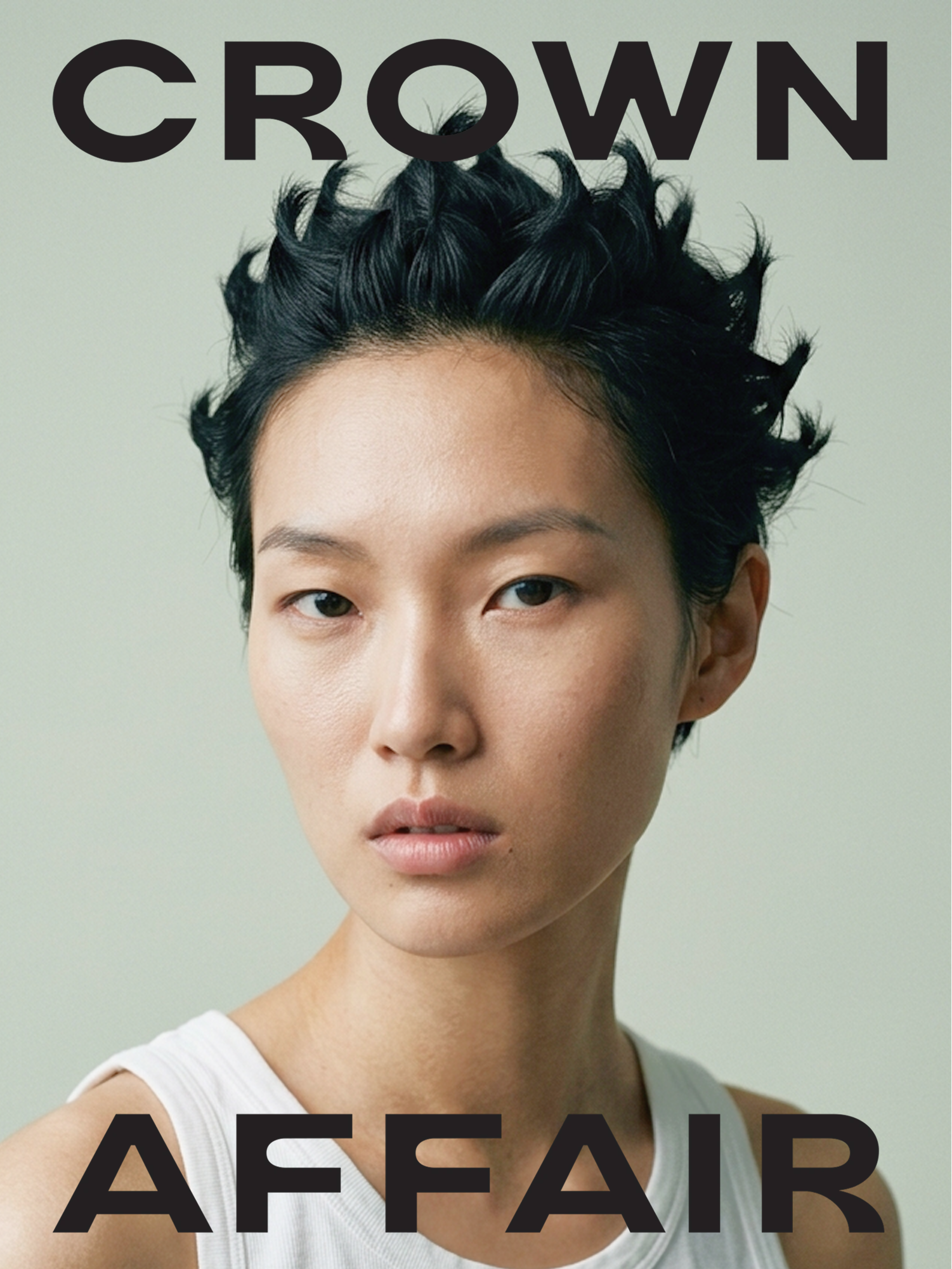 Close-up portrait of a young Asian man with short, tousled black hair, wearing a white sleeveless top, against a neutral background.