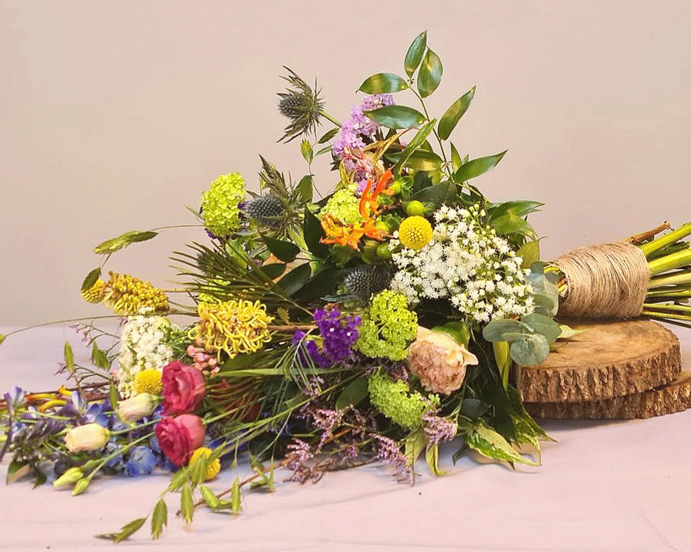 Natuurlijk rouwboeket met gele, paarse en witte bloemen.jpg