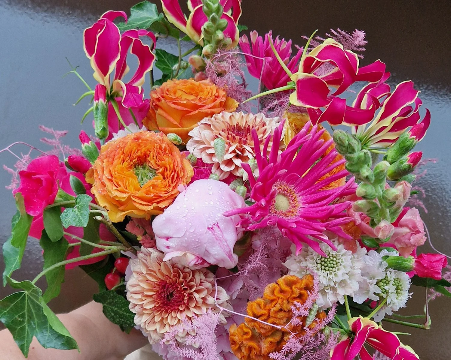 Kleurrijk bruidsboeket met roze, oranje en rode bloemen.jpg