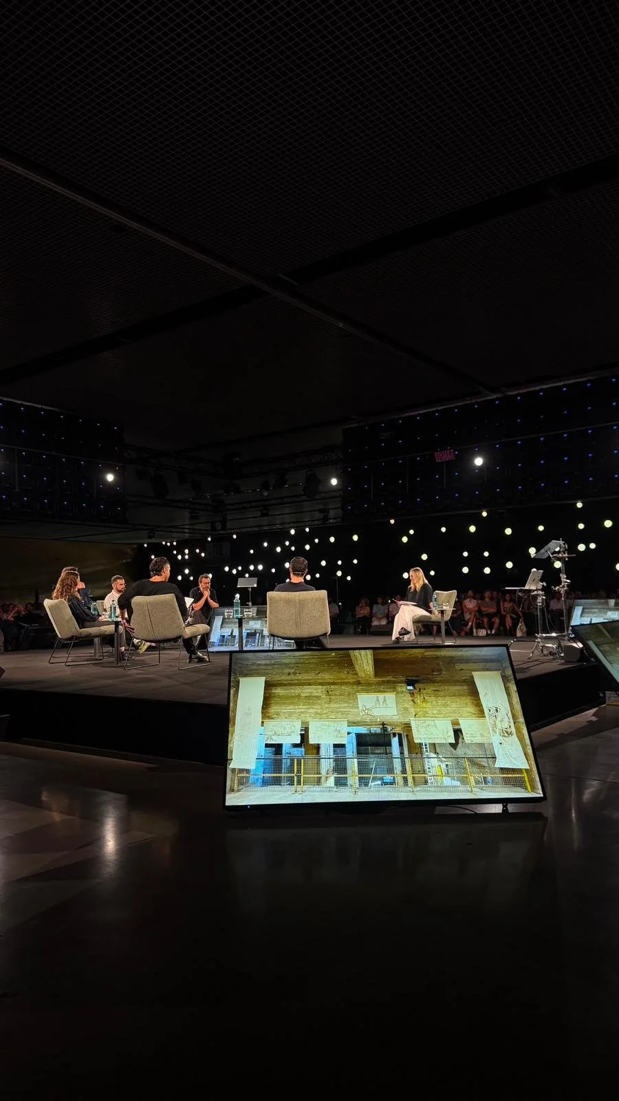 Plenary session of the UIA World Congress of Architects 2026 in Barcelona, with an image of the Revised Cartographies installation on a screen in the foreground.