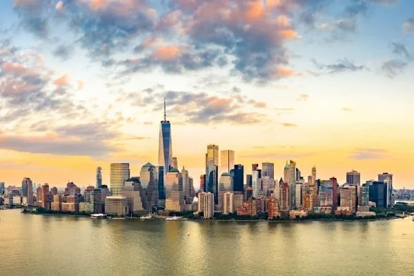 Skyline of New York City with One World Trade Center at sunset, view from across the river.