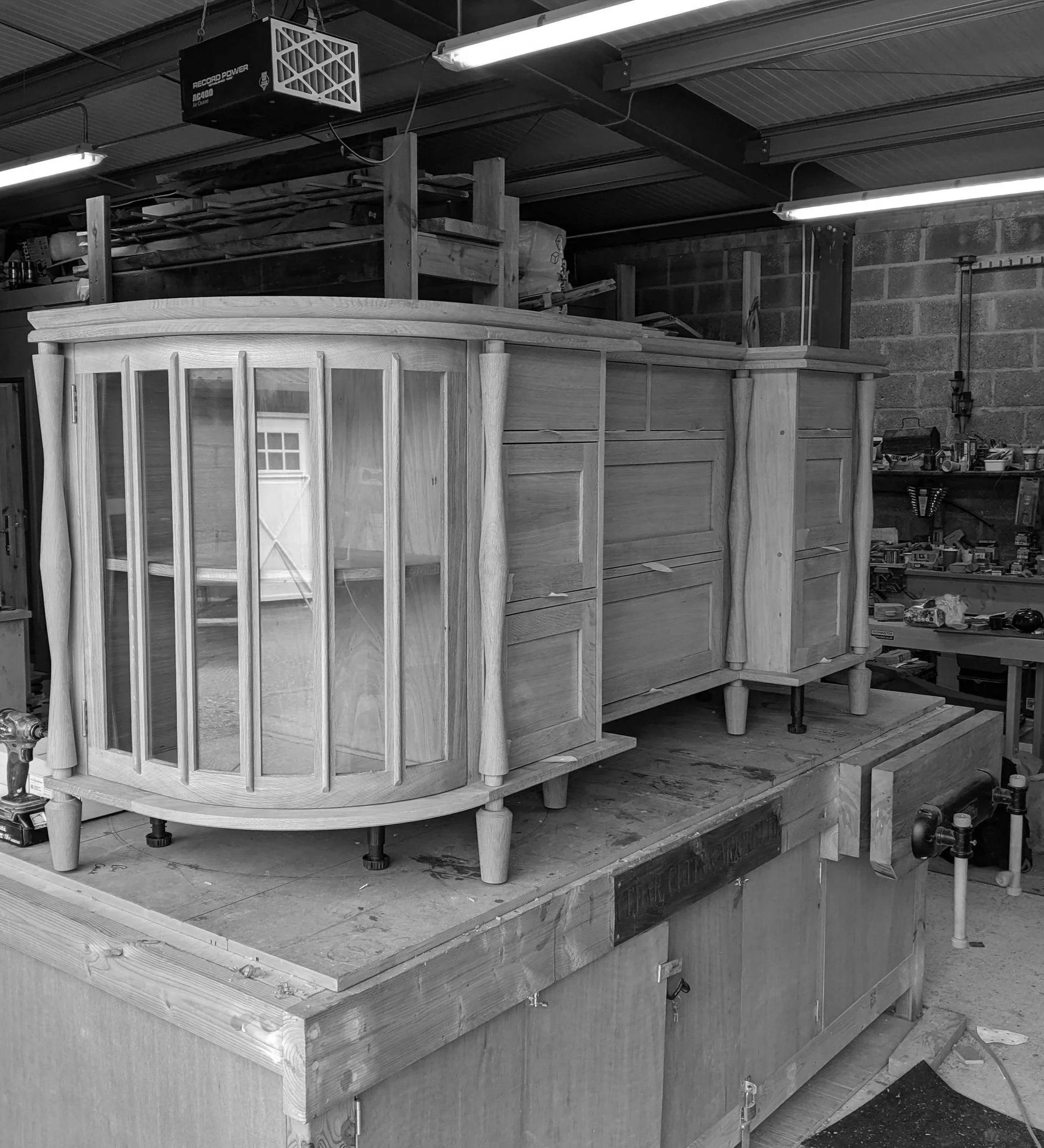 Solid wood and glass sideboard at the workshop.