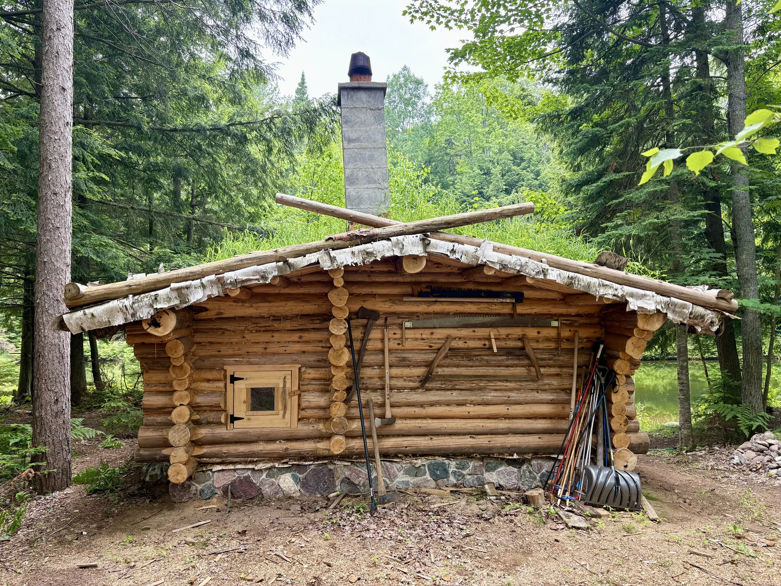 Traditional Finnish sauna with wood-fired stove and cedar benches at Bear Tree Homestead