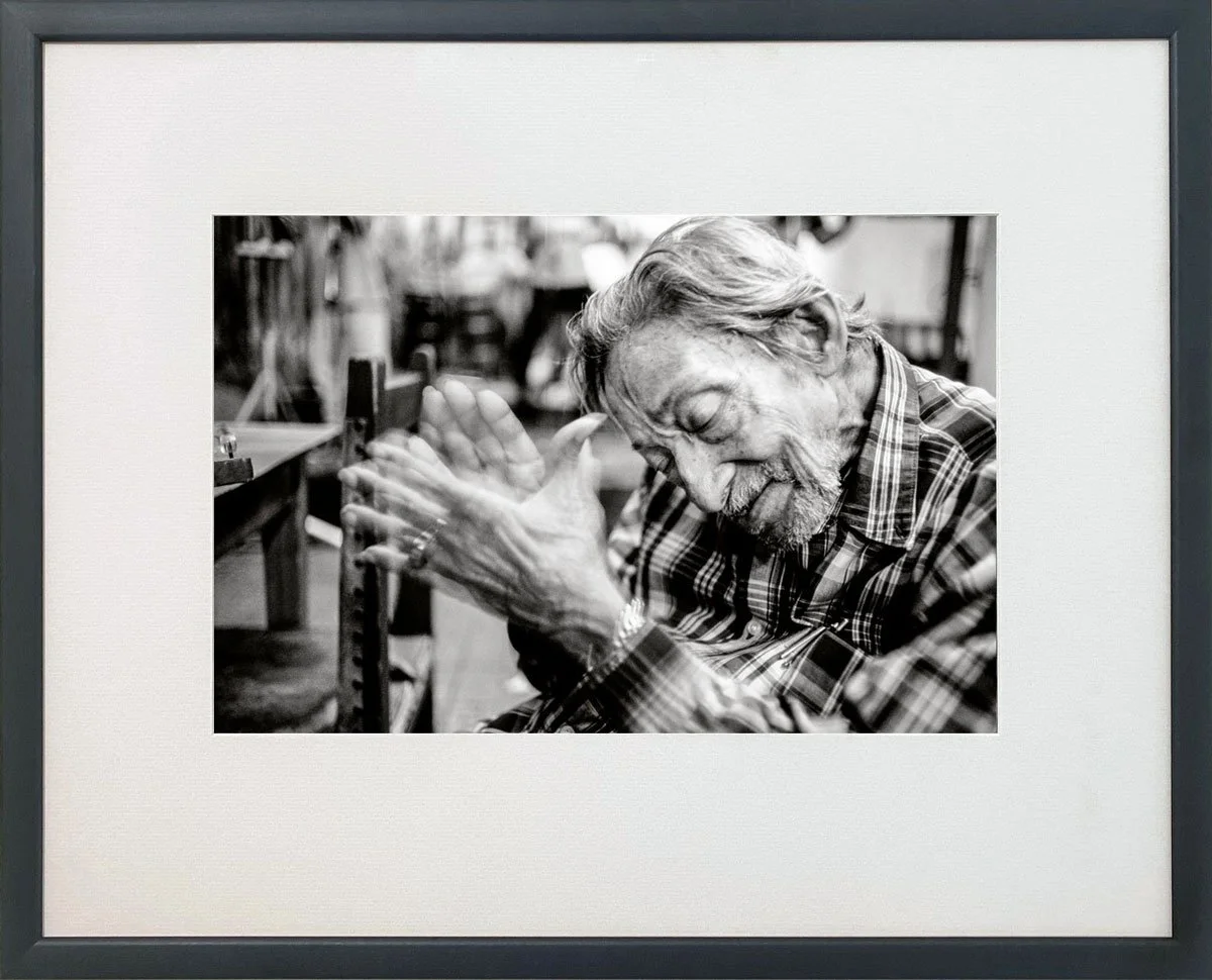 Framed black and white photograph by James Sparshatt of Dagoberto, an old musician in Holguin, Cuba.  Dagoberto is clapping his hands in time to the music, his eyes are closed as he relives his memories.  His expression is of contentment.