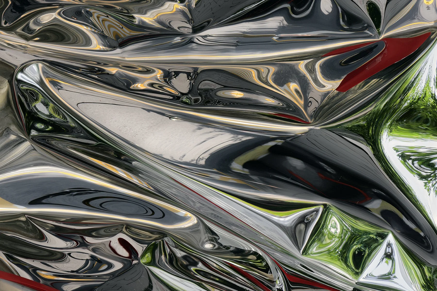 Abstract image of shiny, distorted metallic surfaces with reflections of greenery and sky by Seoul based contemporary Korean Photographer Kim Sunik.