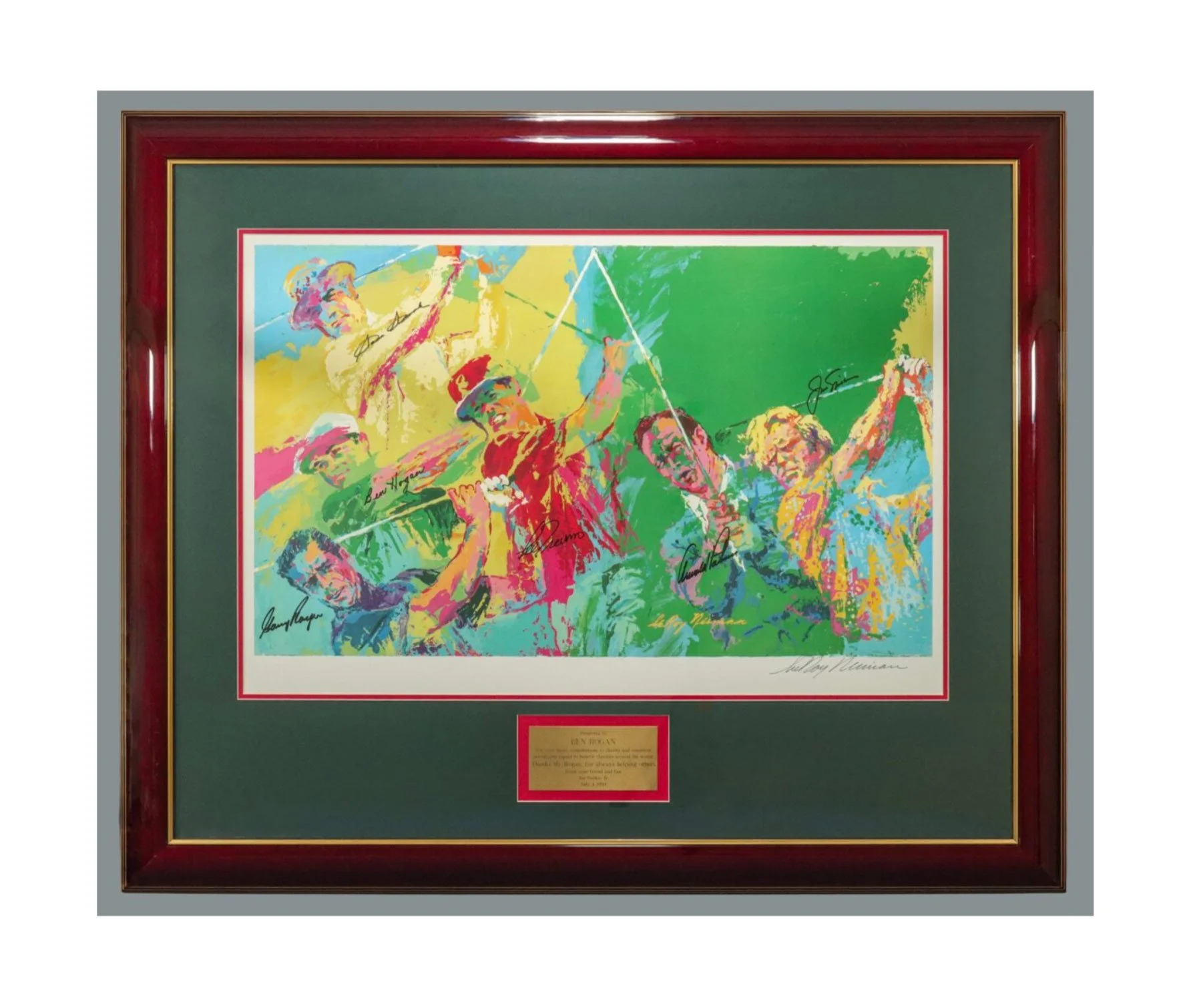 Colorful framed artwork depicting golfers swinging clubs with signatures and a plaque below.