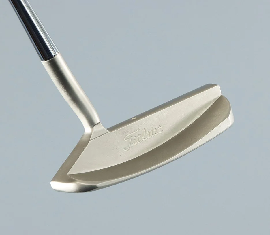 Close-up of a Titleist golf putter against a light background.