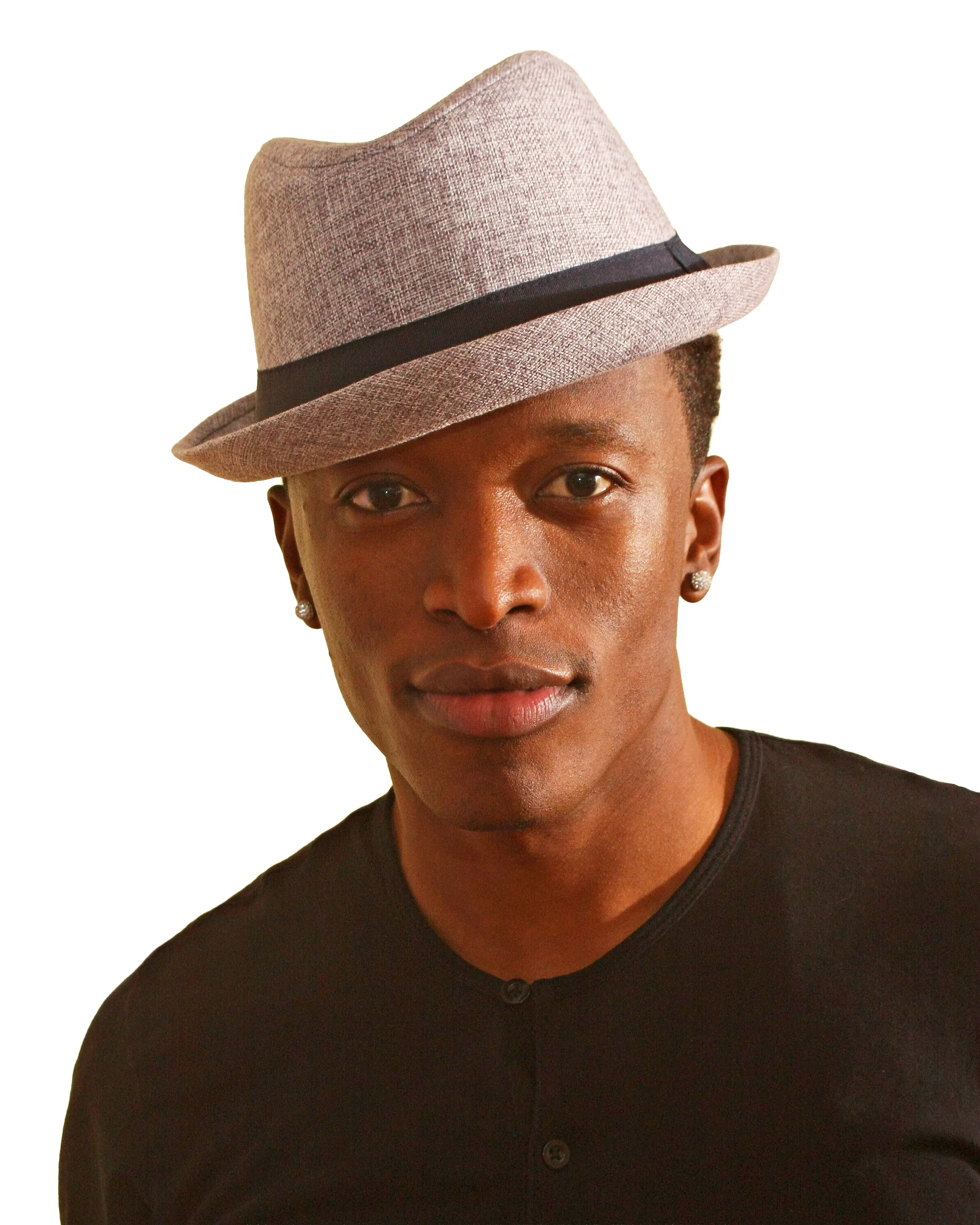 A person wearing a light gray fedora hat with a black band, black shirt, and earrings, posing against a white background for actor's headshot.