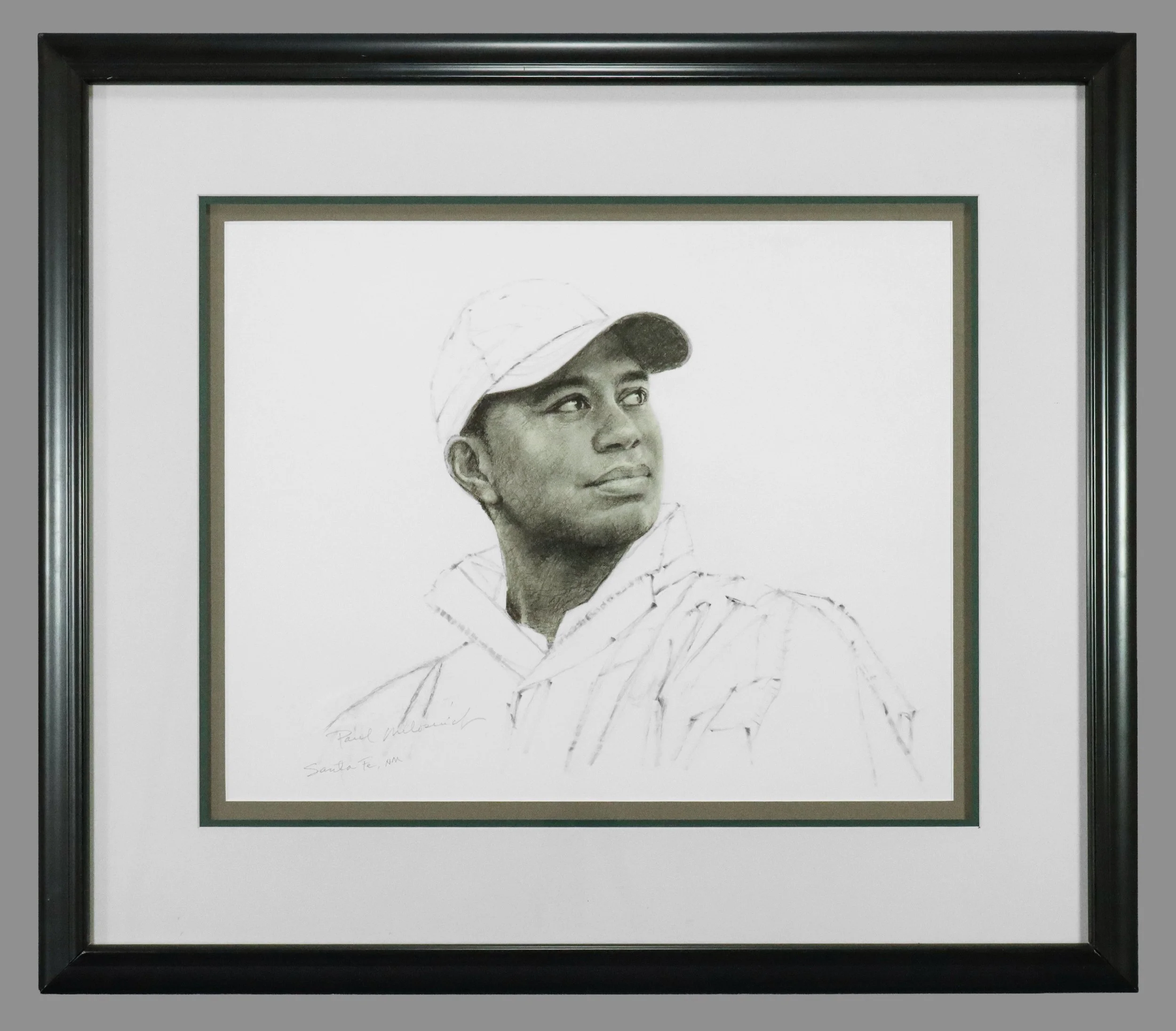 A framed pencil sketch of a golfer Tiger Woods wearing a baseball cap and jacket, looking to the right, signed by the artist, Paul Meliar. Text on the sketch indicates it is from Santa Fe, NM.
