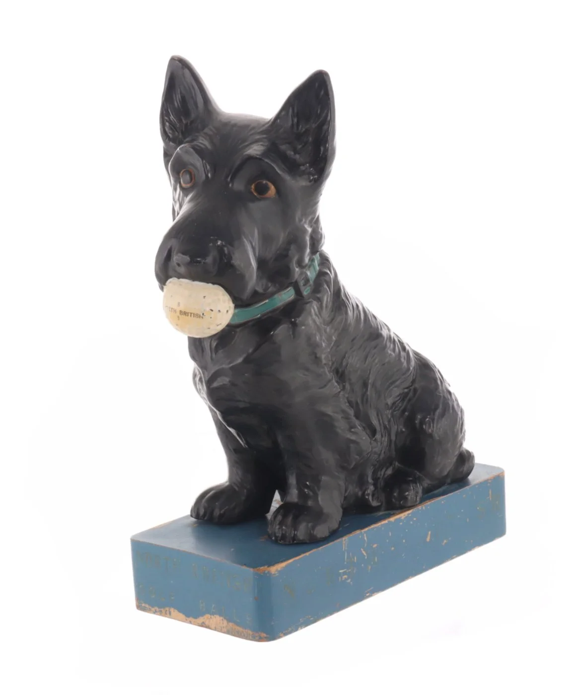 Black Labrador Retriever sculpture with a bone in its mouth, sitting on a blue base.