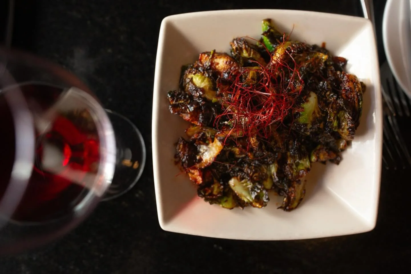 Dark, bold, and just the right amount of heat.

Our fried Brussels sprouts are tossed in a harissa vinaigrette that brings a smoky kick, balanced perfectly with a glass of red. 

#chattanoga #westvillagechatt #westvillagechattanooga #chattanoogaeats 
