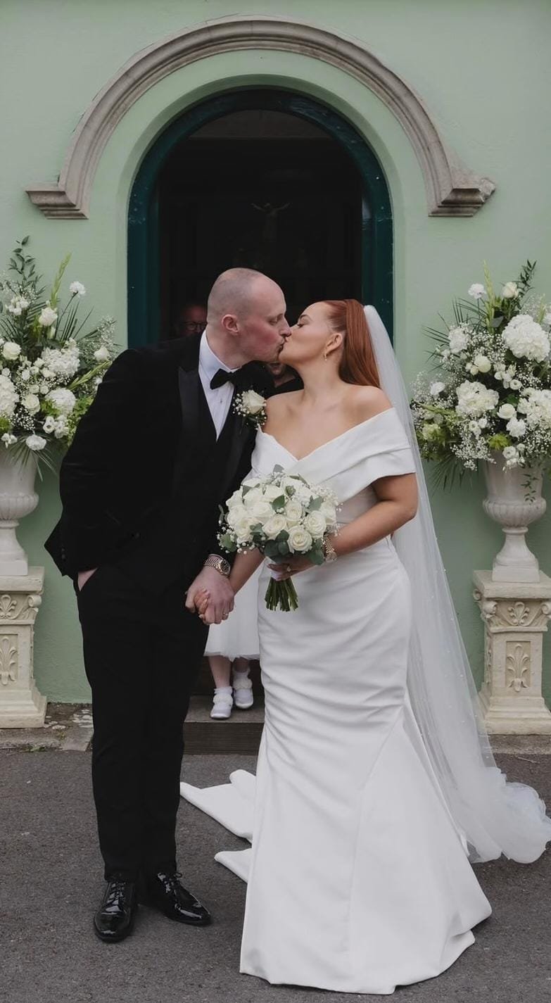 A bride in her white gown and her husband in his black tuxedo on their wedding day at the heritage hotel killenard