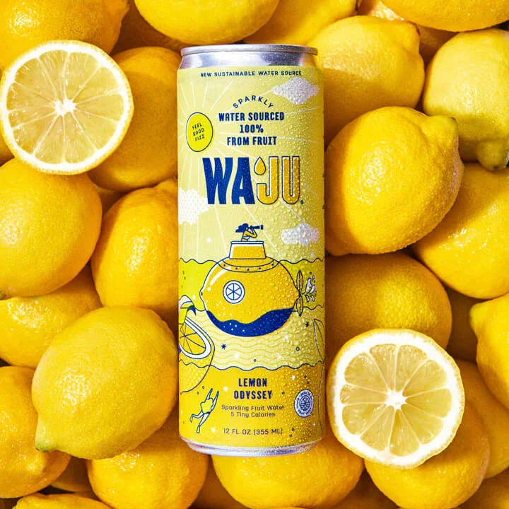 A can of Wai Jü Lemon Odyssey flavored sparkling water surrounded by fresh lemons, with one lemon sliced in half to show the inside.