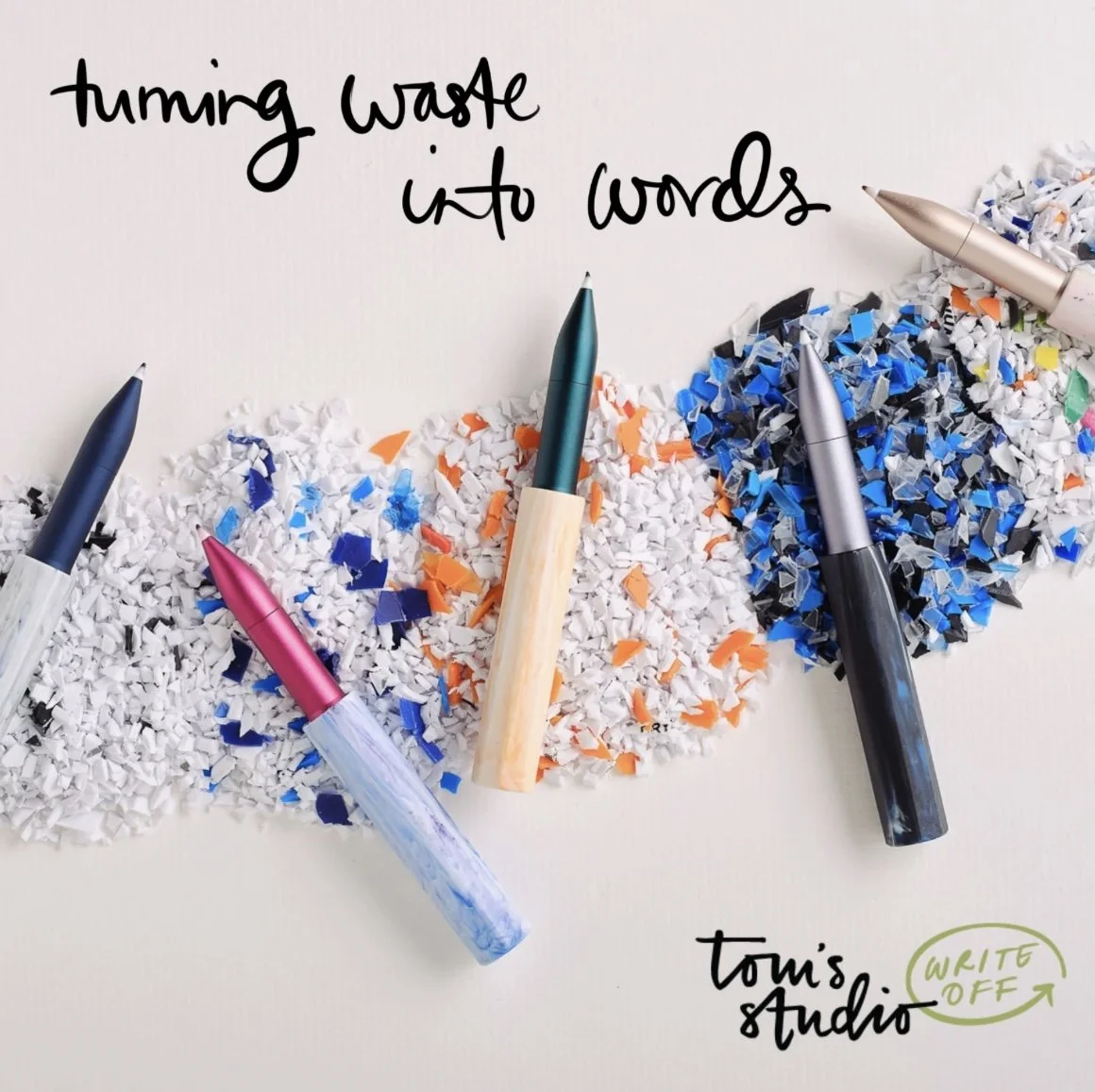 Pens and shredded paper arranged to spell out 'turning waste into words' on a white background, with the note 'Tom's Studio' and 'Write Off' written in green.