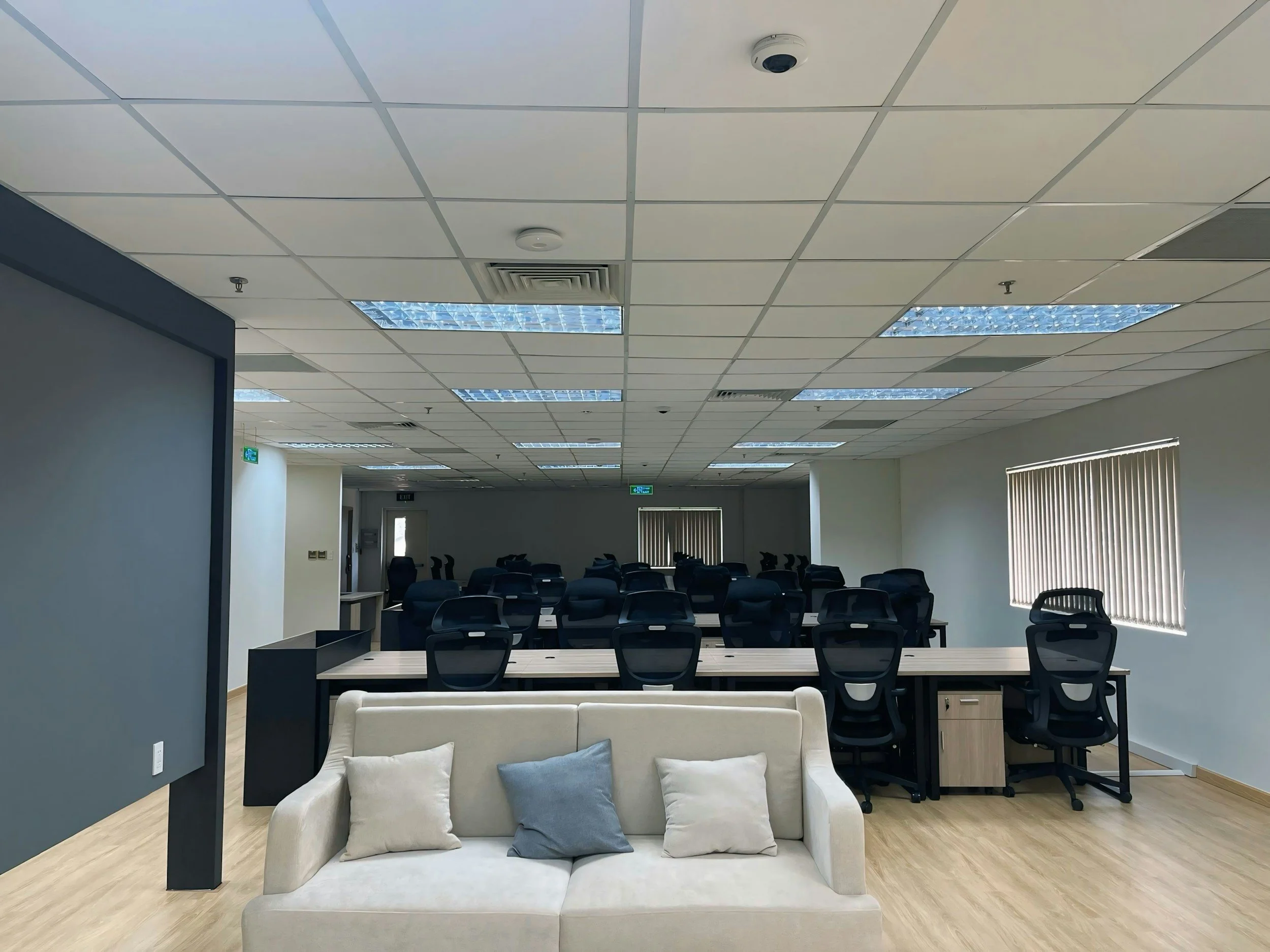 Office with an acoustical drop ceiling tile grid