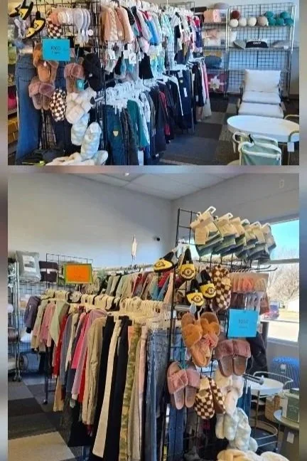 Clothing racks with children's and adult clothing, including shirts, pants, and dresses, in a thrift store or secondhand shop.