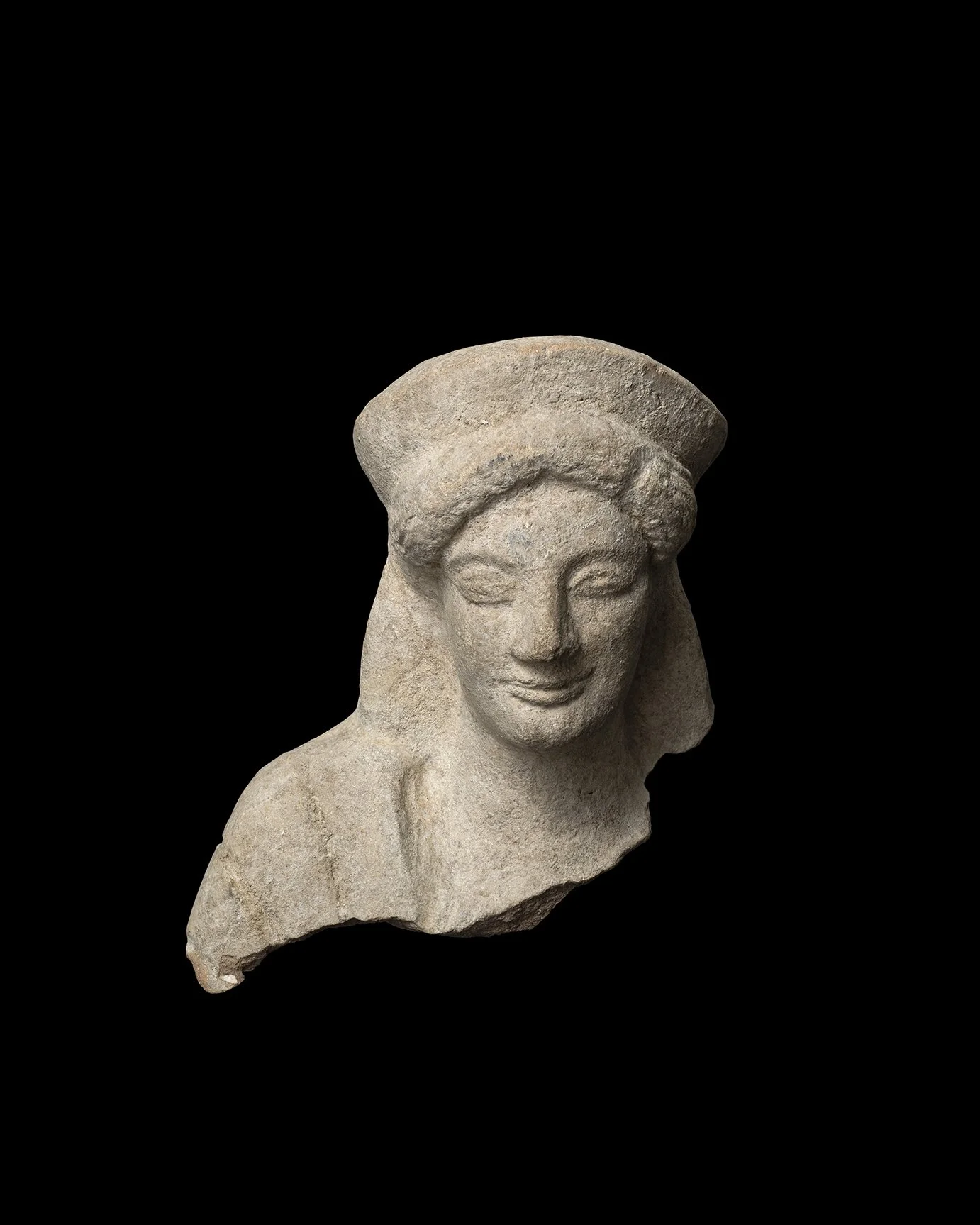 A Greek terracotta bust of a kore
