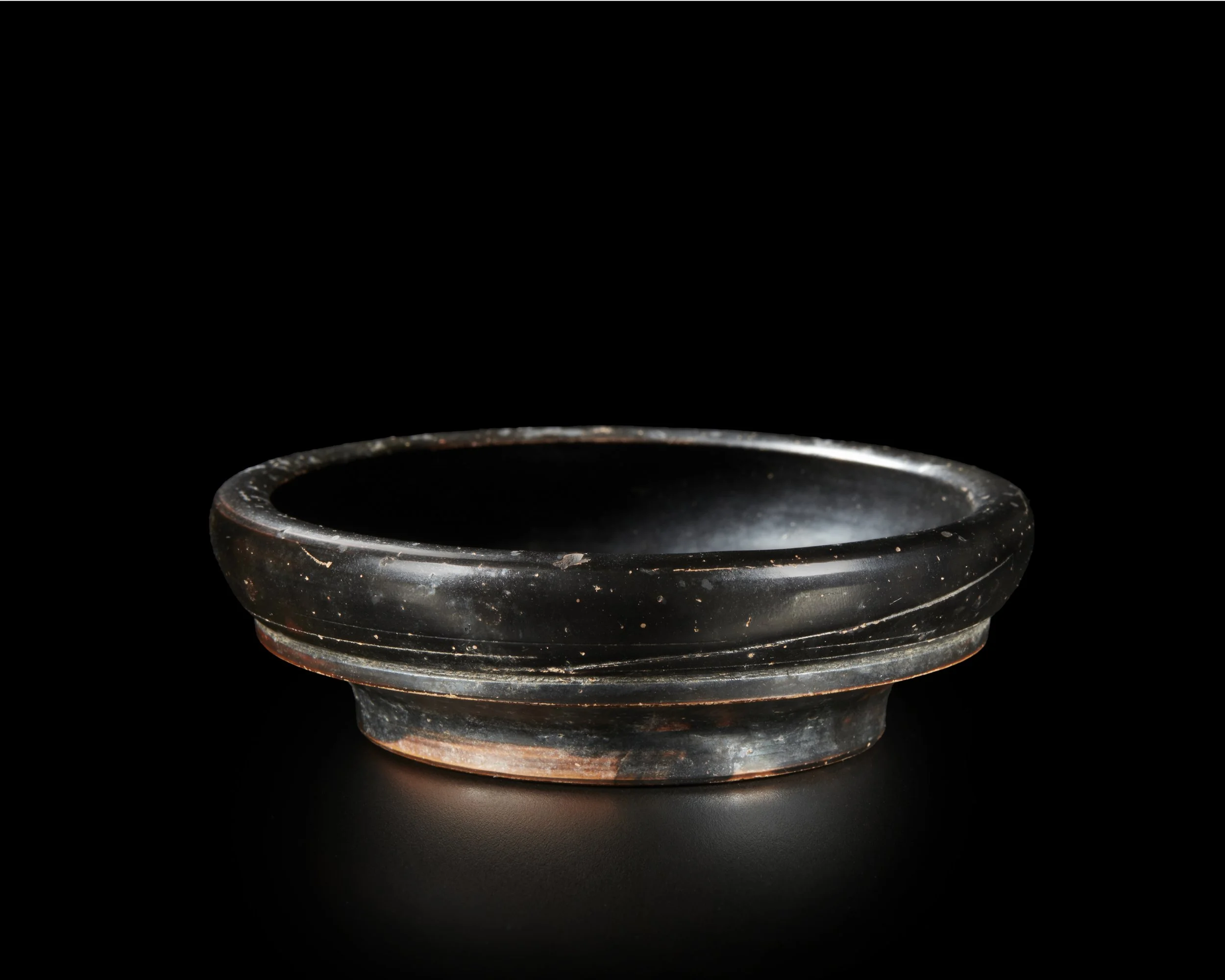 A small Greek black-glazed dish