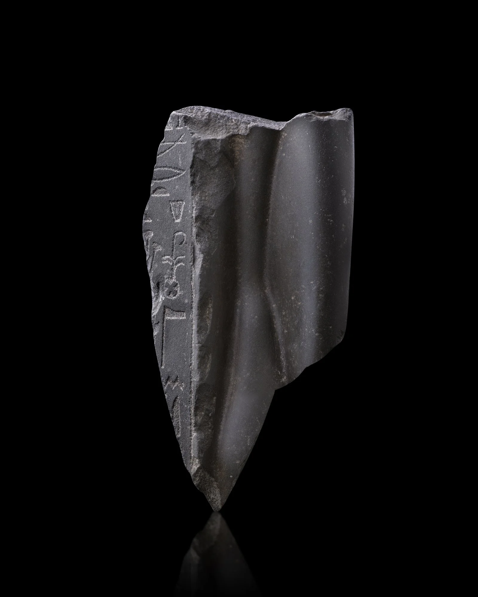 An Egyptian greywacke fragmentary torso of a Ptolemaic queen