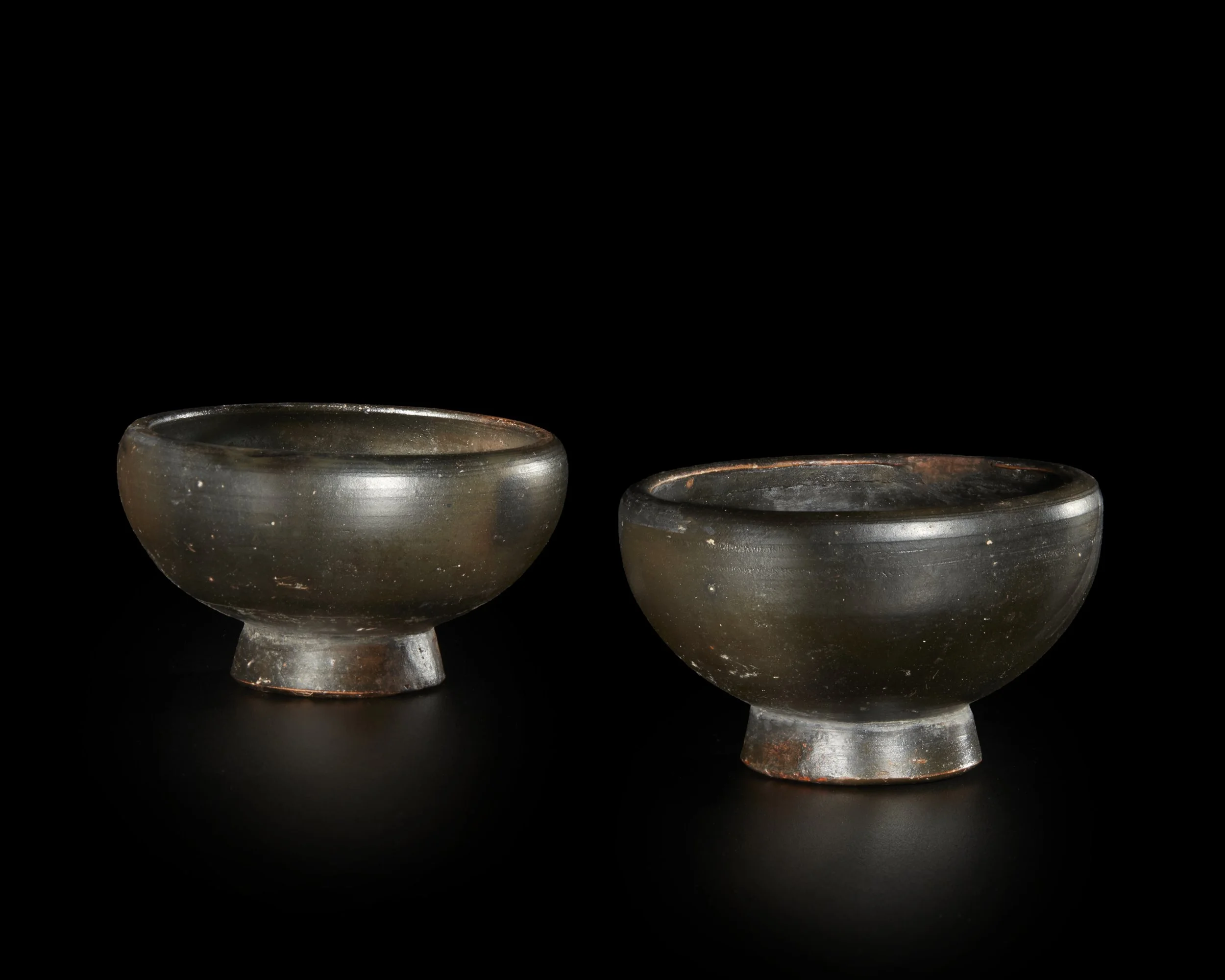 A pair of Greek black-glazed cups