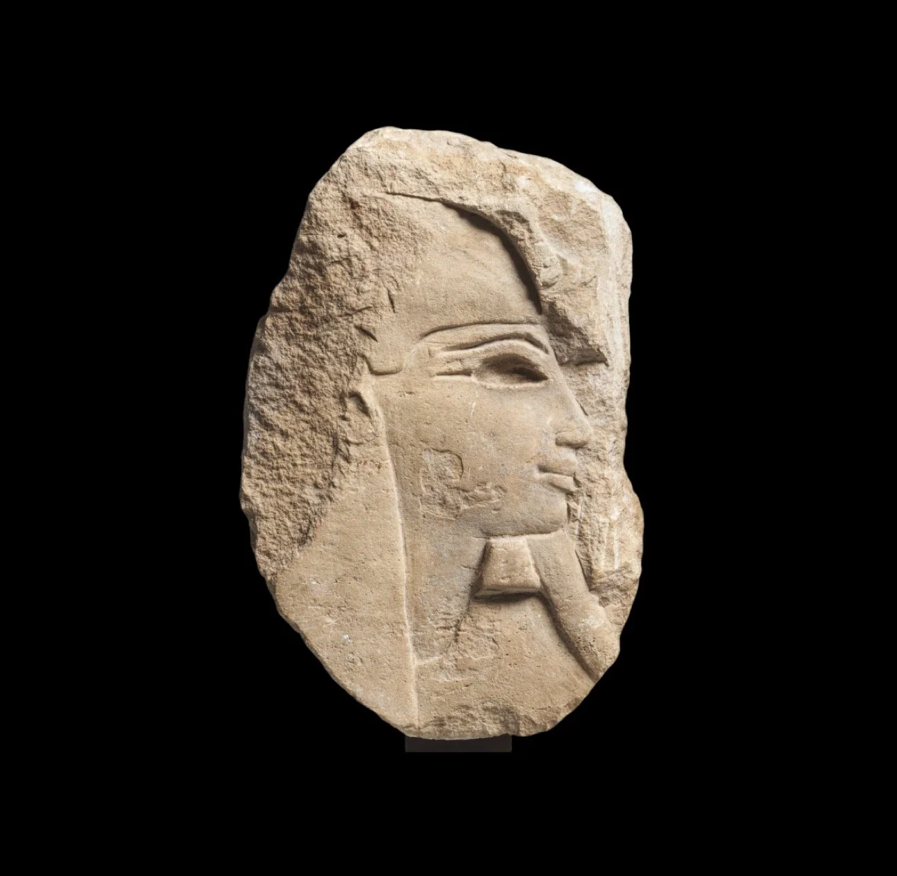 An Egyptian relief fragment of a head in profile 