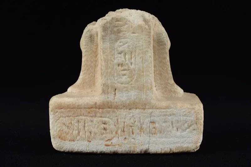 An Egyptian calcite statue fragment inscribed for Queen Nefertari