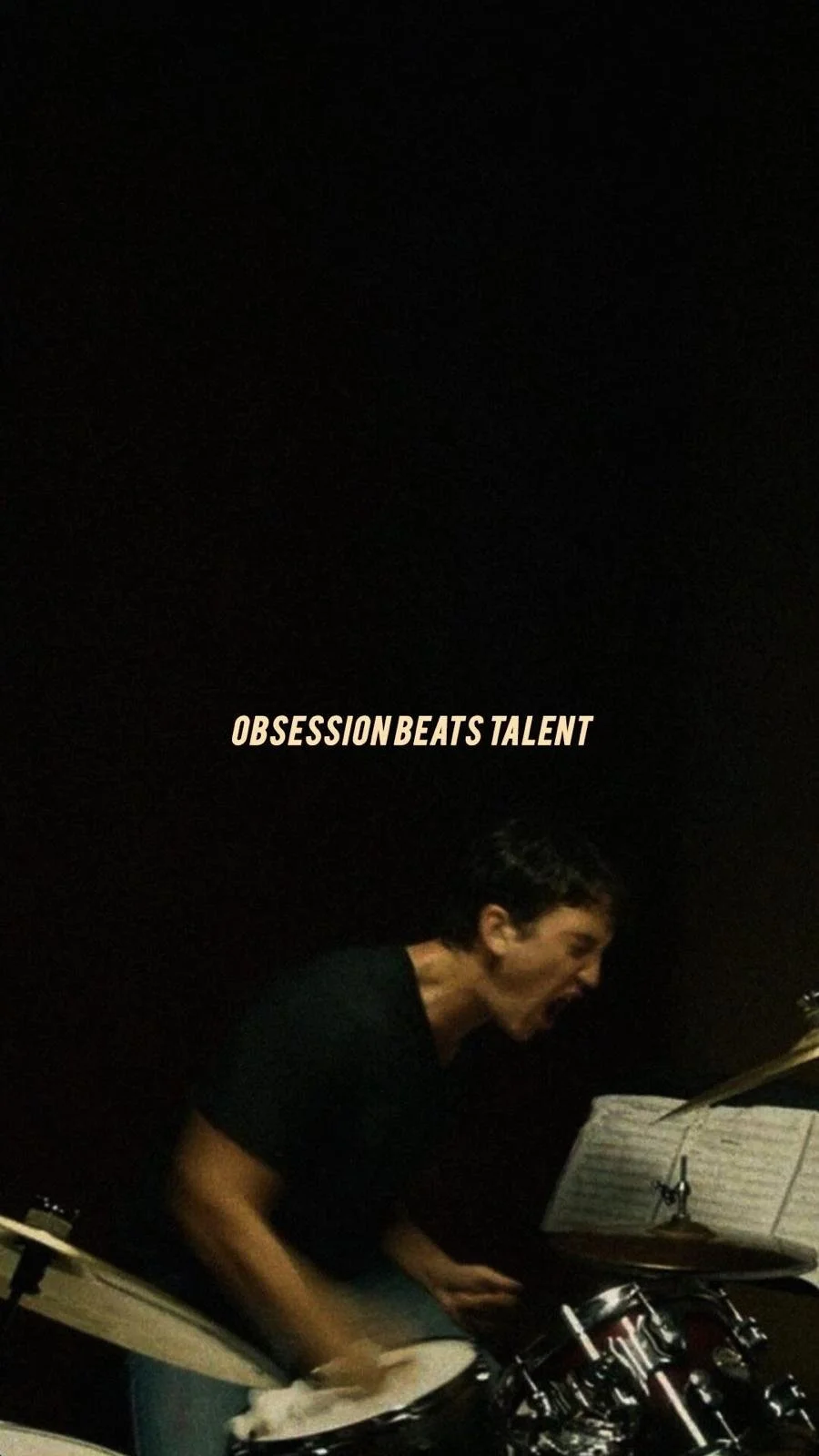 A person playing drums passionately with an open mouth, with the words "OBSESSION BEATS TALENT" written above.