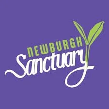 Logo of Newburgh Sanctuary with a purple background and green leaves.