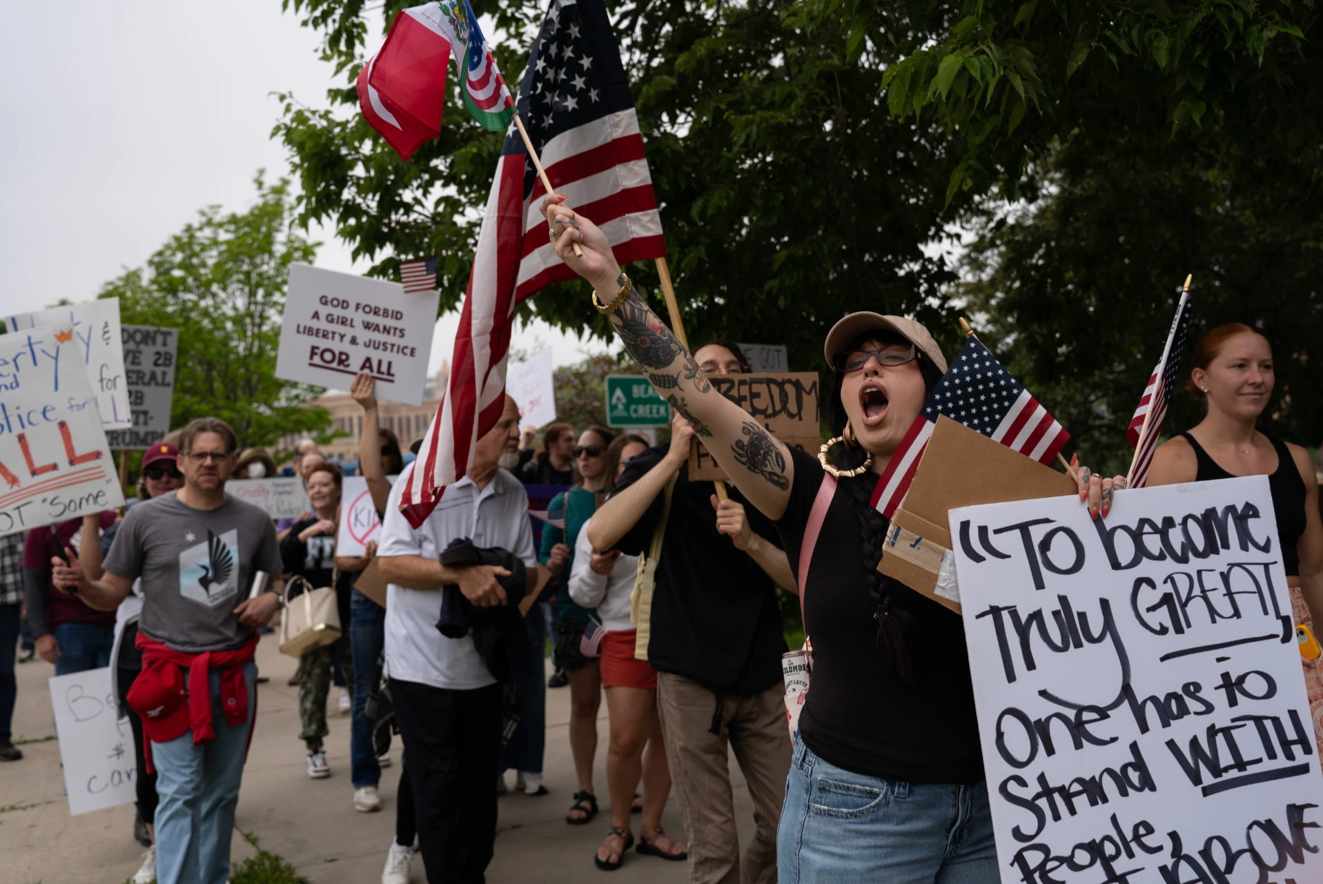 Rae James holds a flag displaying the Mexican and United States flags during the "No Kings" protest on Saturday, June 14, 2025 in Rochester.  (Post Bulletin)