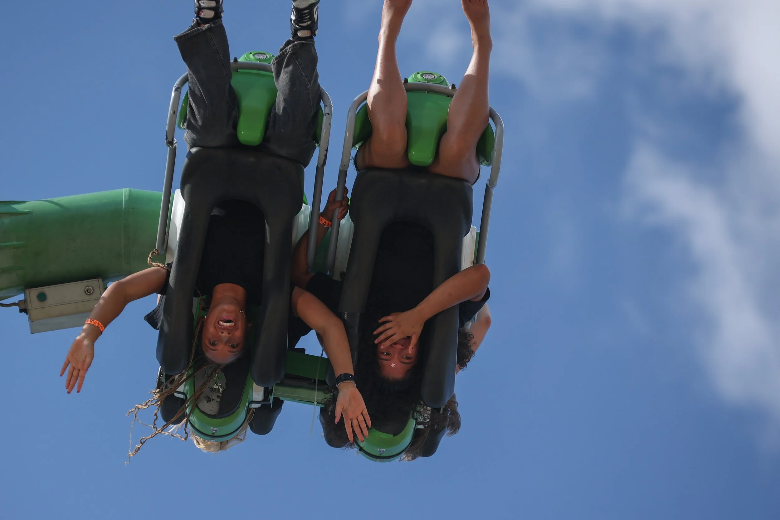 Eliza Marshall and Janea Gaston enjoy a carnival ride at the Olmsted County Fair on Saturday, July 26, 2025 in Rochester. (Post Bulletin)